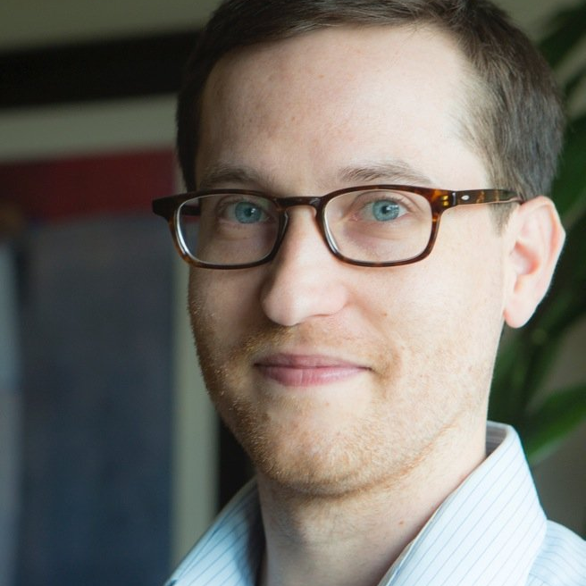 Andy Weith from ASW Global Consulting wears glasses and a striped shirt as he looks at the camera.