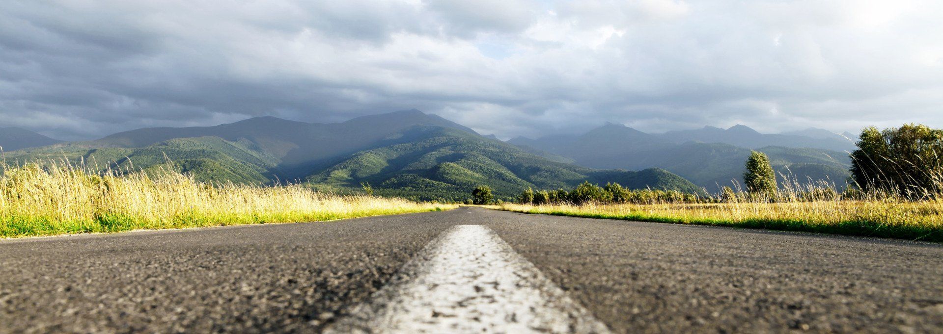 looking ahead on a road with mountains in the distance