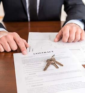Lawyer Holding a Paper — Escrow Services Beach CA Lawyer Holding a Paper — Escrow Services Beach CA