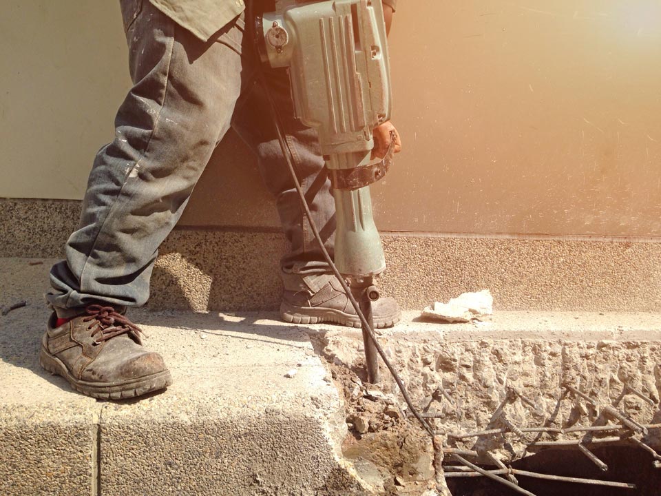 Construction Worker Drilling the Floor | Kissimmee, FL | Carl's Concrete Cutting & Drilling Inc.