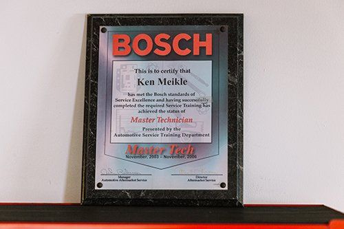 Bosch Master Technician certificate for Ken Meikle, framed on a wall.