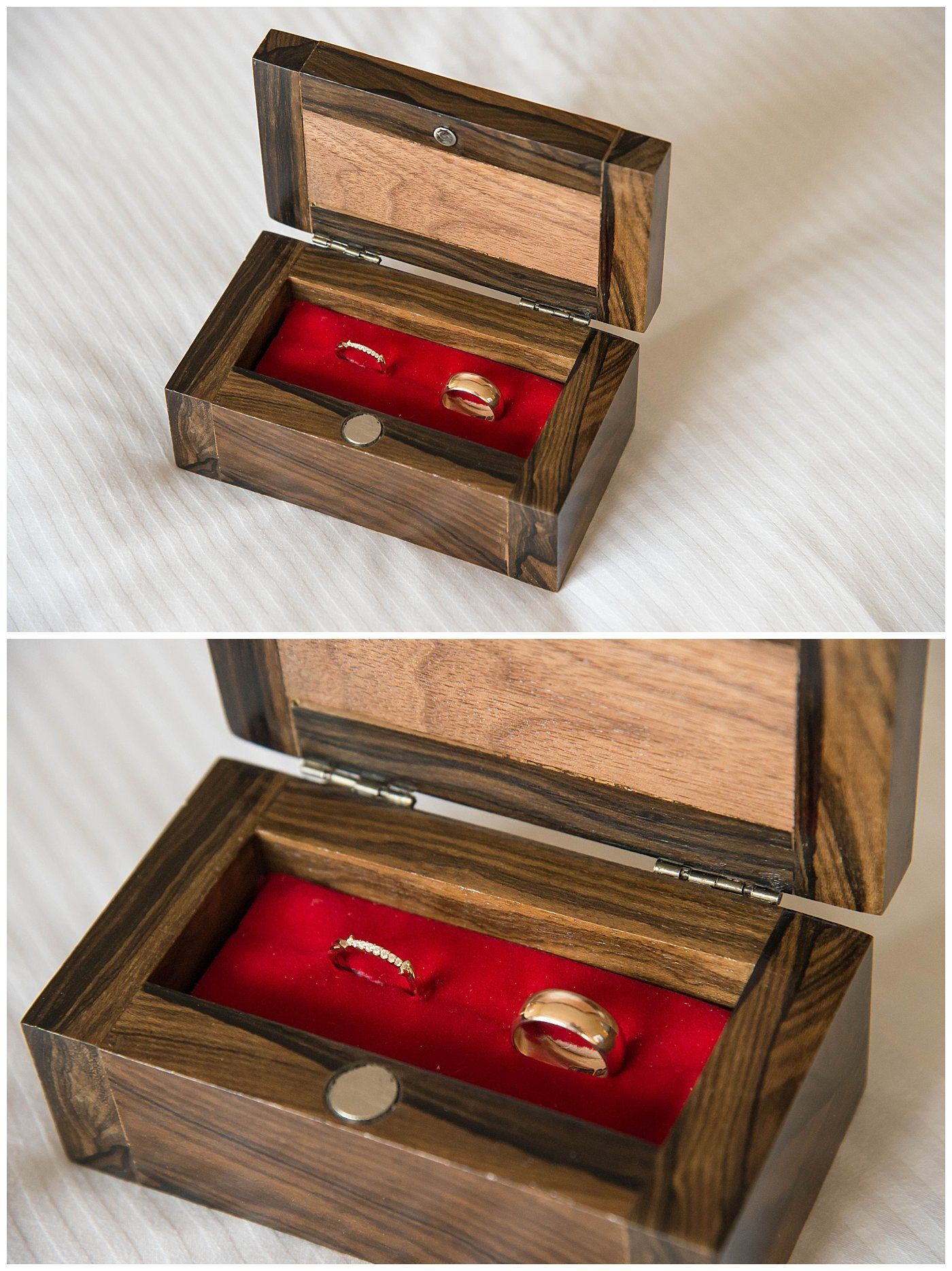 Open wooden ring box with red velvet lining, holding two gold rings.