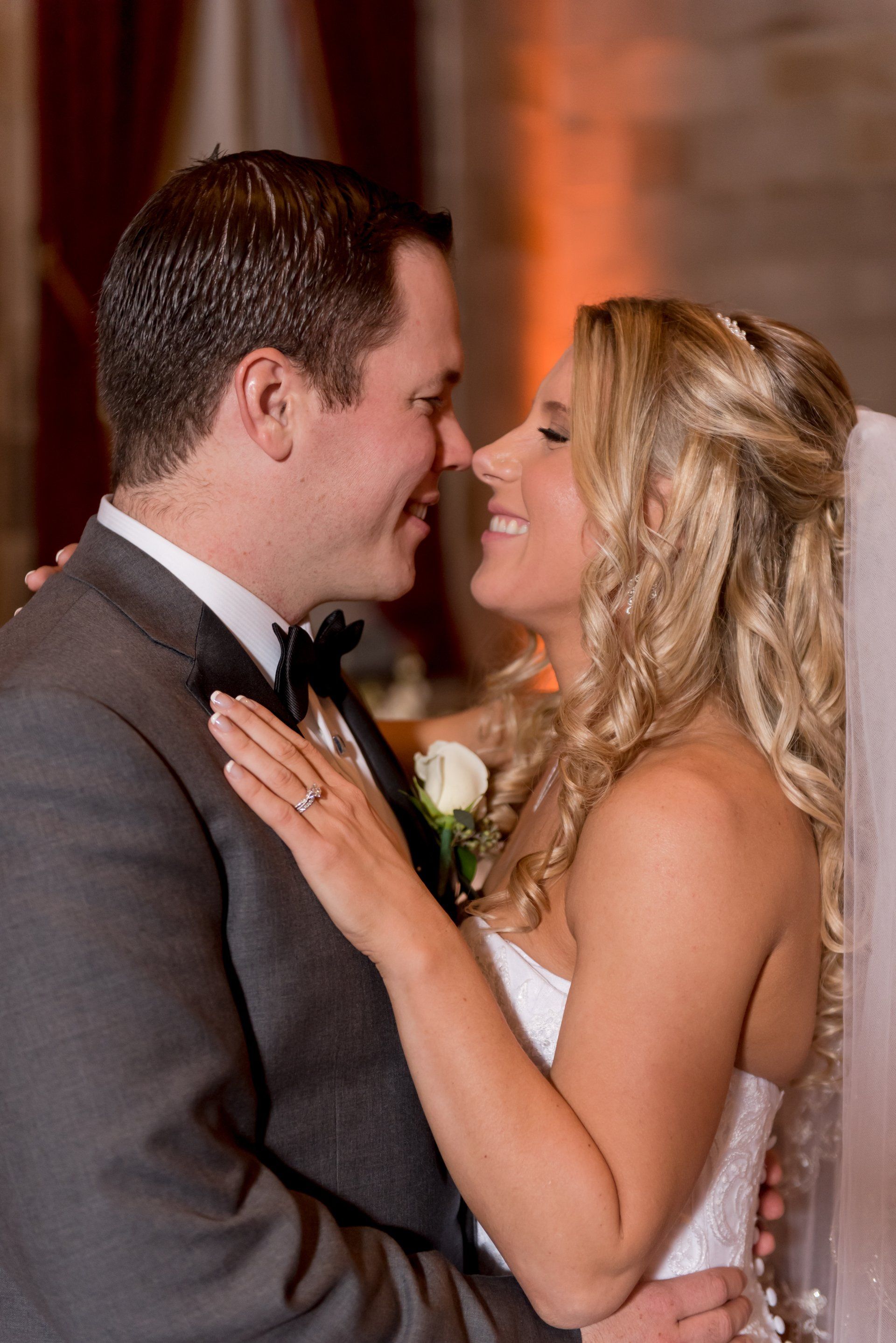 Bride and groom embracing and smiling at their wedding reception