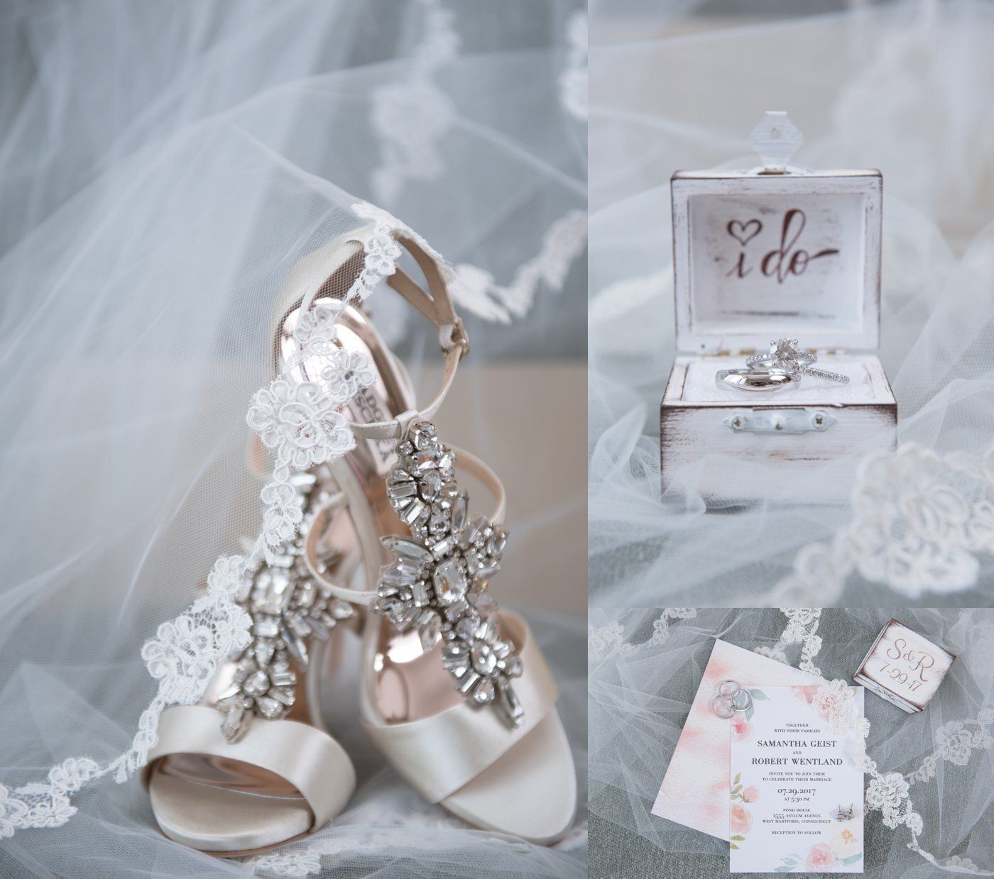 White bridal heels with crystal straps beside a ring box, invitation, and veil on a soft gray surface.