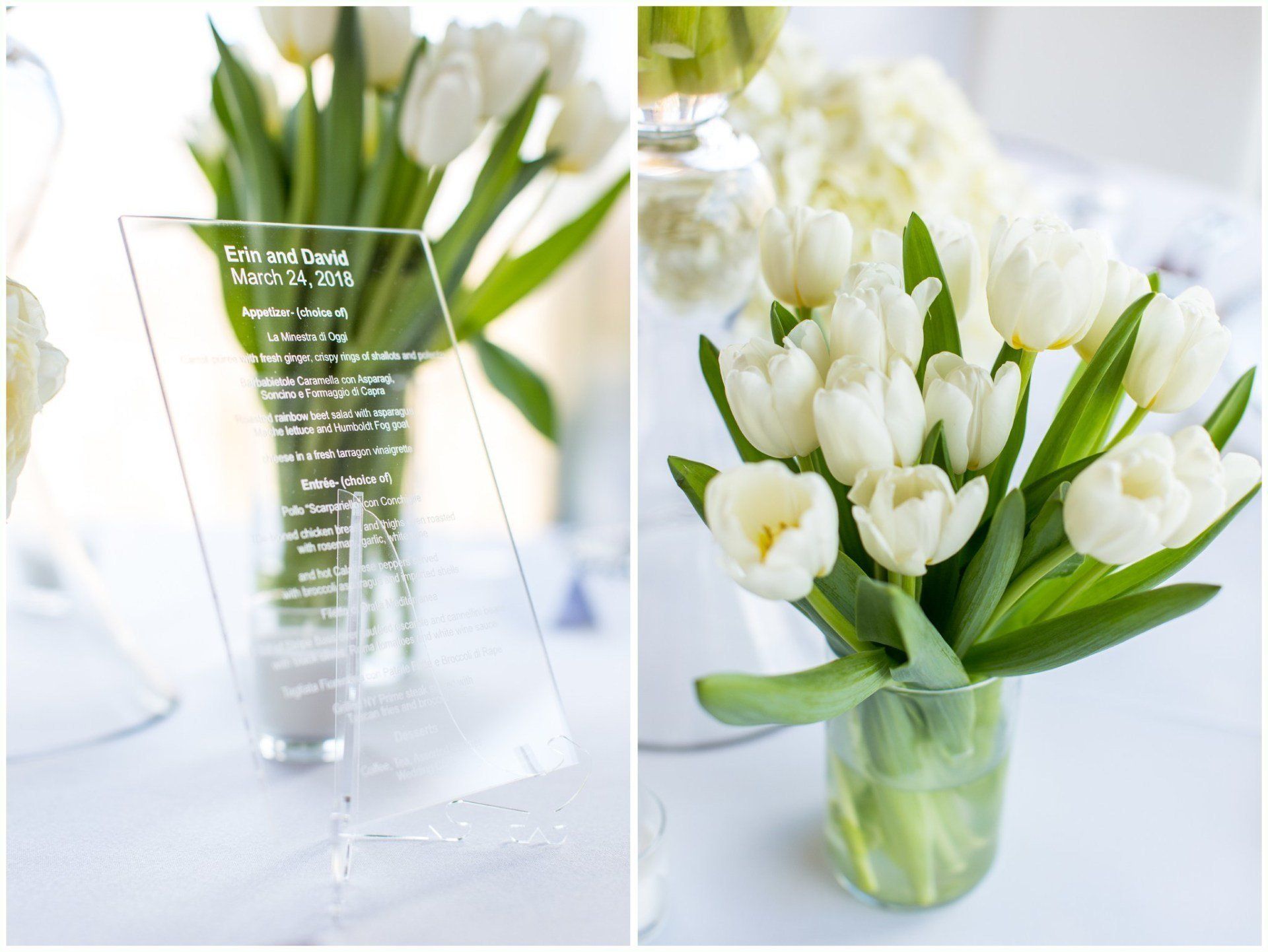 White tulips in a green glass vase on a bright table beside an acrylic sign