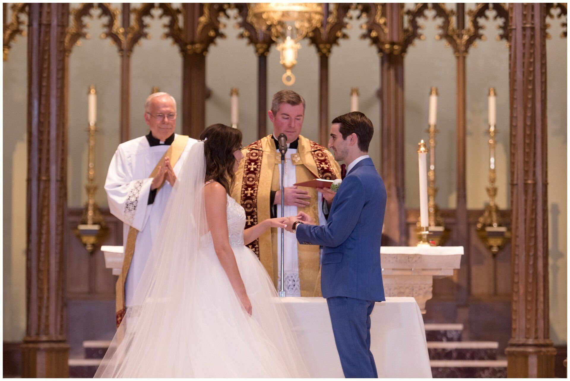 Wedding couple exchanging vows at an altar with officiant and priest in a church