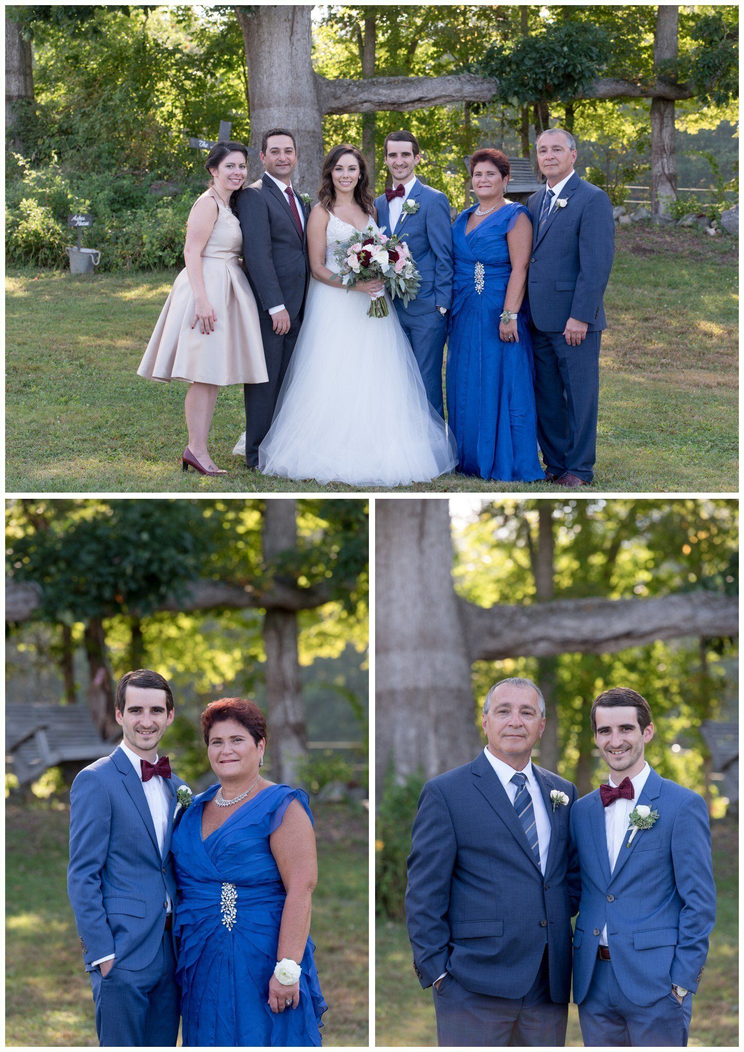 Wedding party posing outdoors by a stone cross, with bride in white and attendants in blue and gray attire.