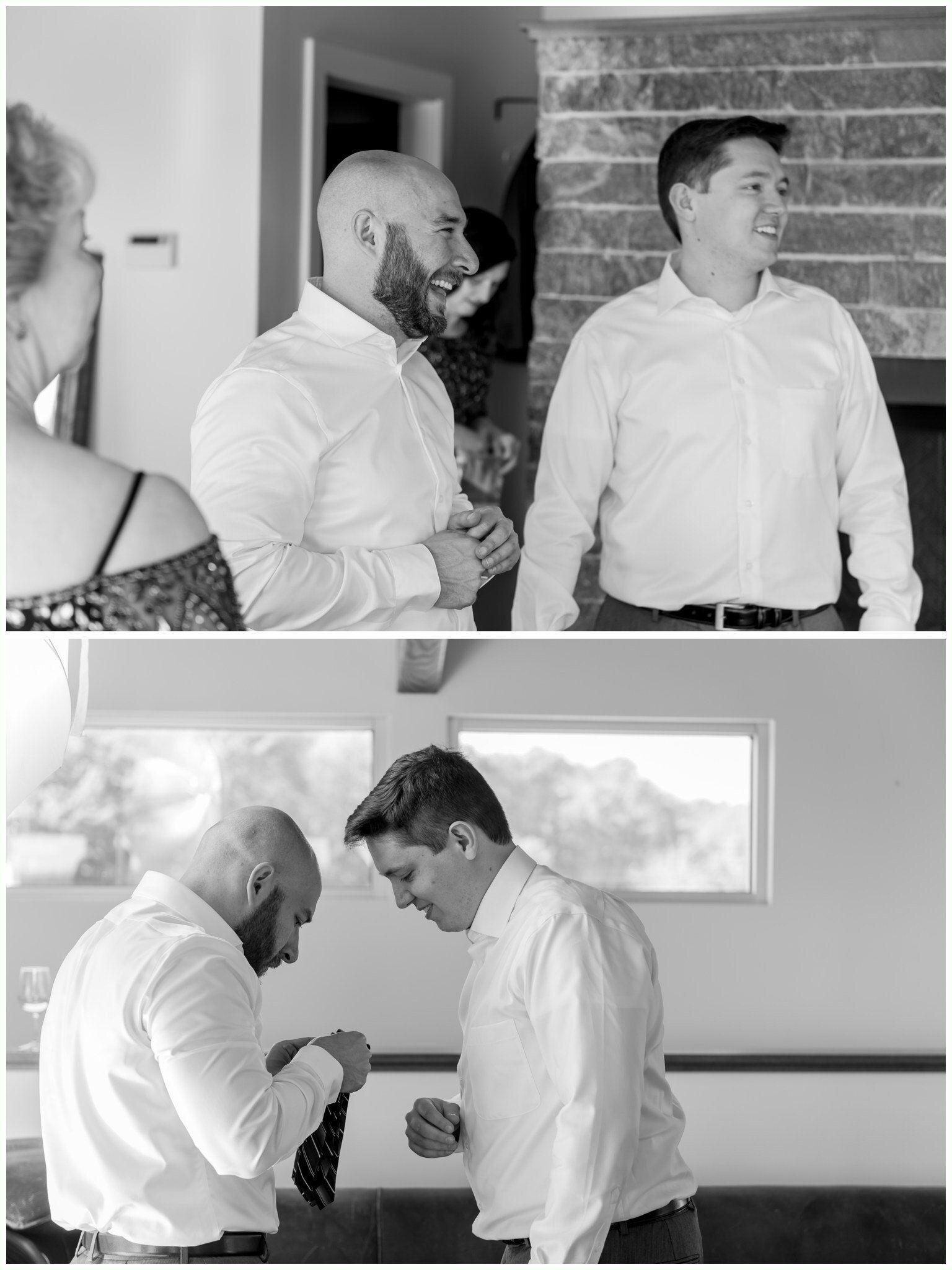 Two men in dress shirts chatting indoors; one adjusts the other’s tie.