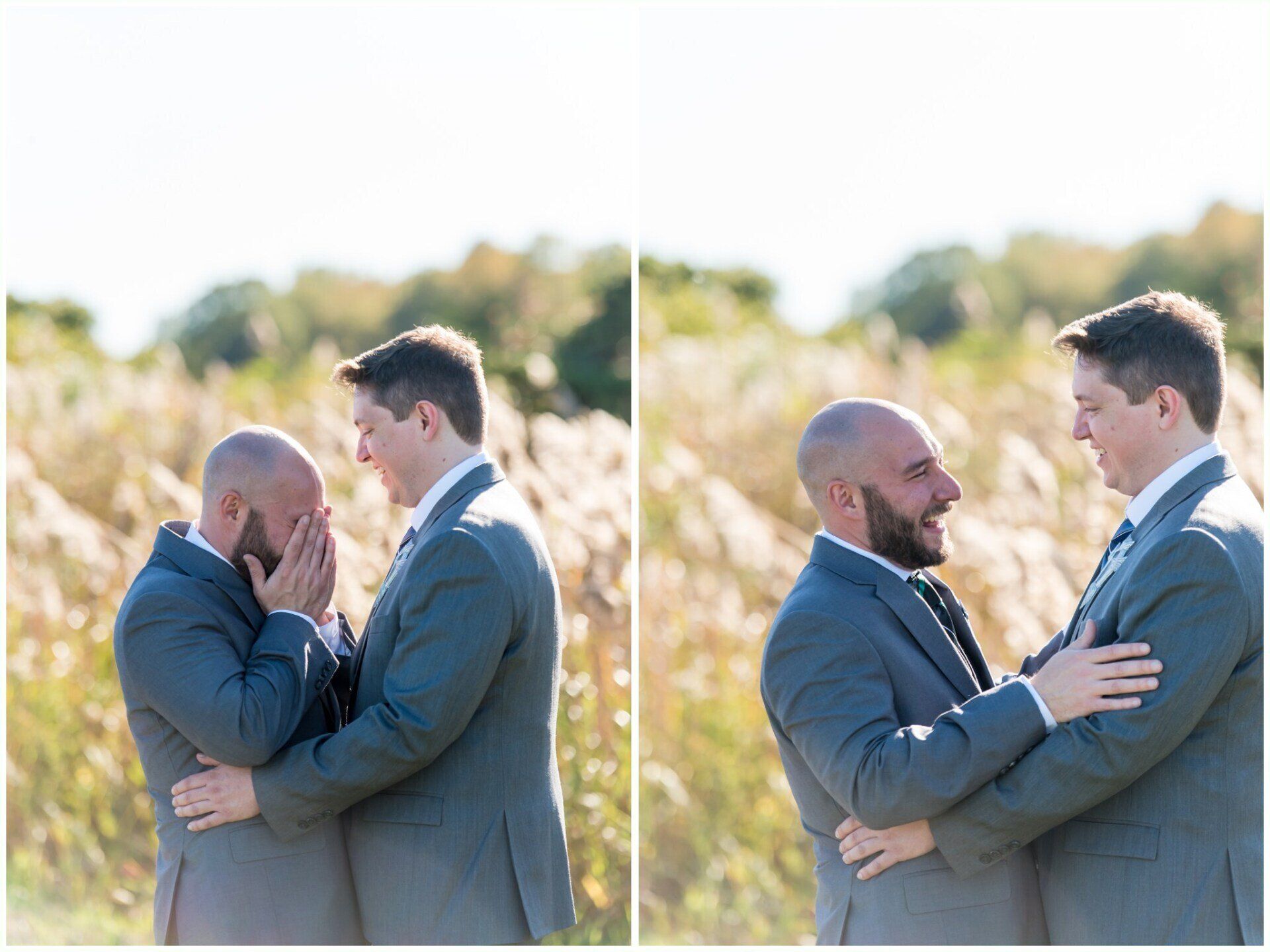 Two men in suits embrace outdoors in a sunlit field, sharing a tender moment.