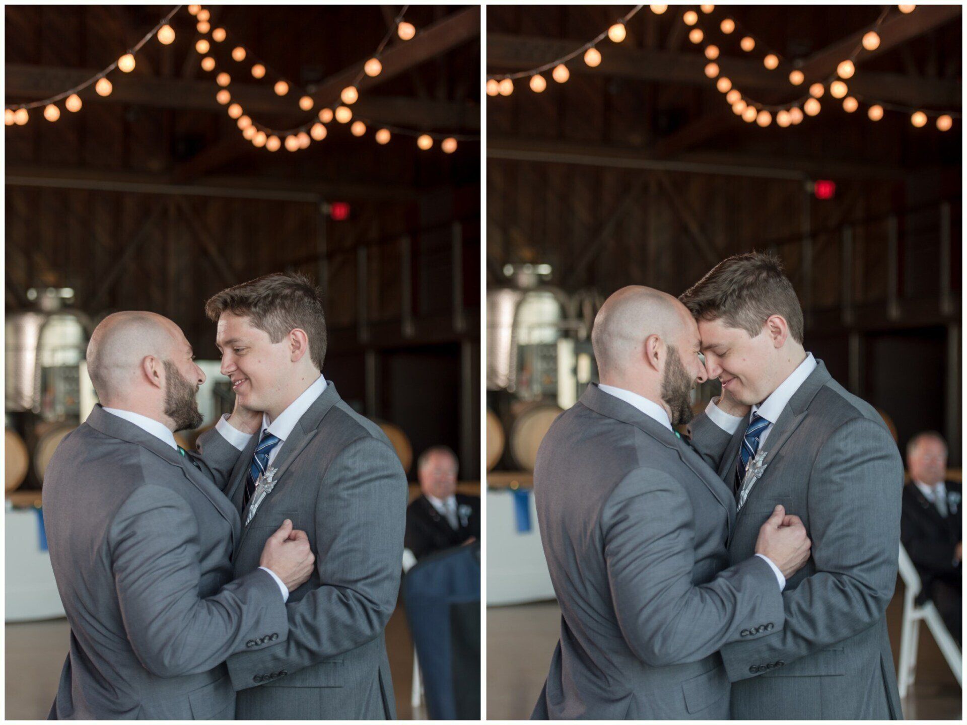 Two men in suits embrace and touch foreheads under warm string lights at a wedding reception