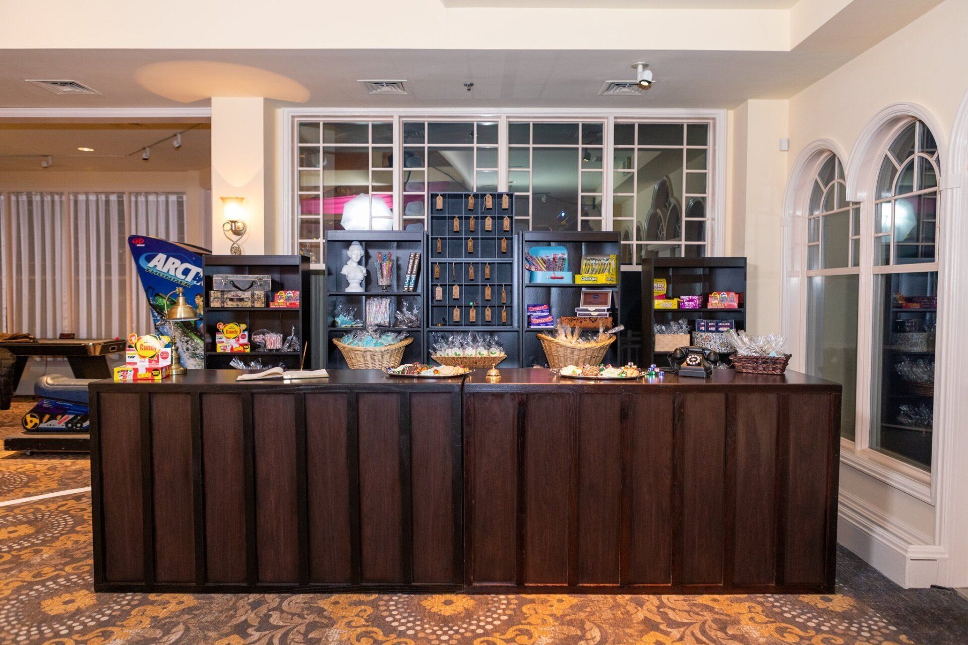 Hotel lobby snack bar with candy and chips on a dark wood counter