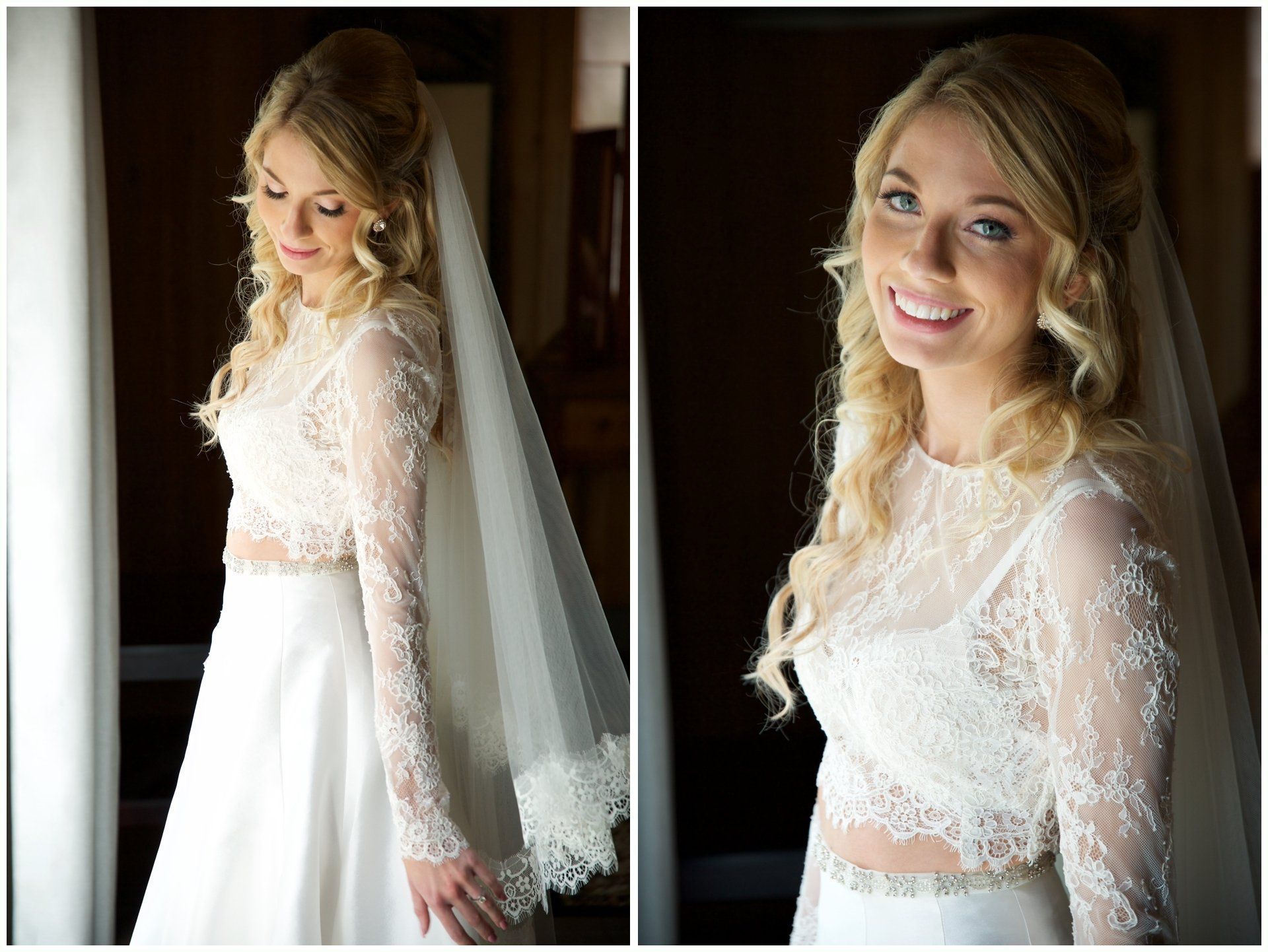 Bride in a lace wedding dress and veil, smiling in a softly lit indoor portrait.
