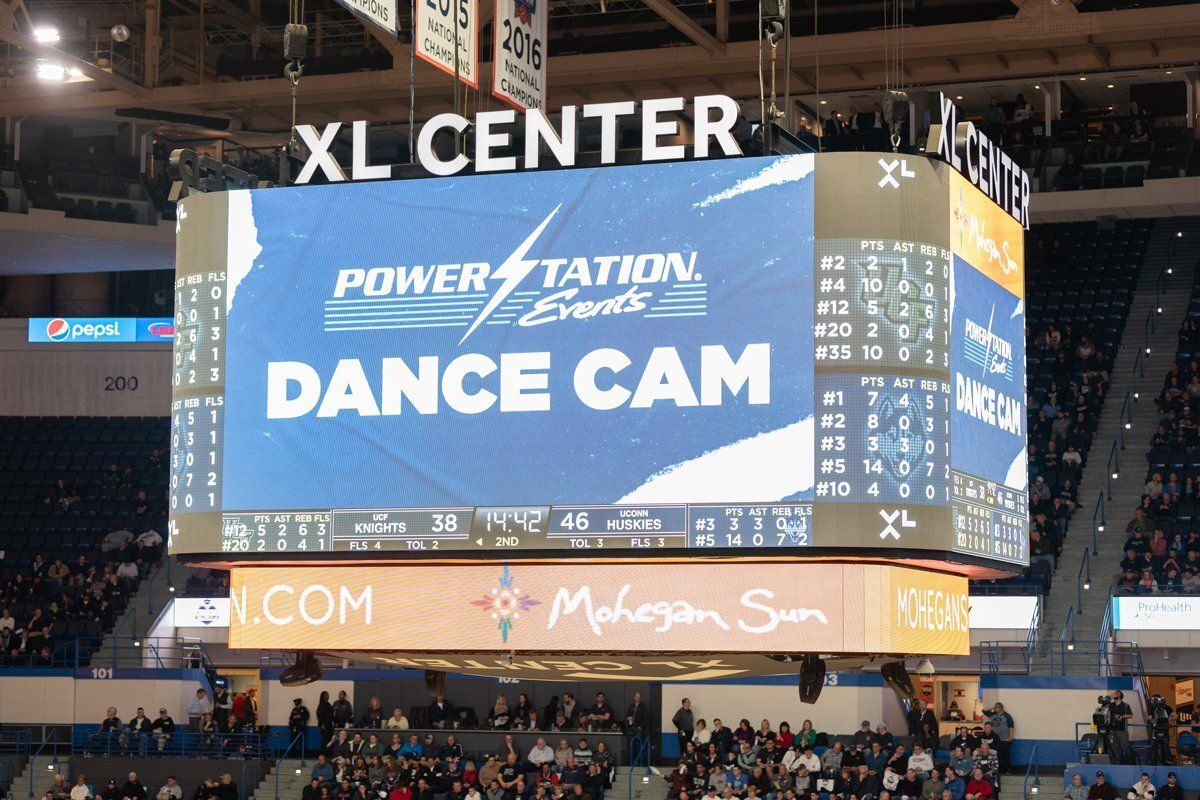 Jumbotron at XL Center displaying “Dance Cam” during a hockey arena event