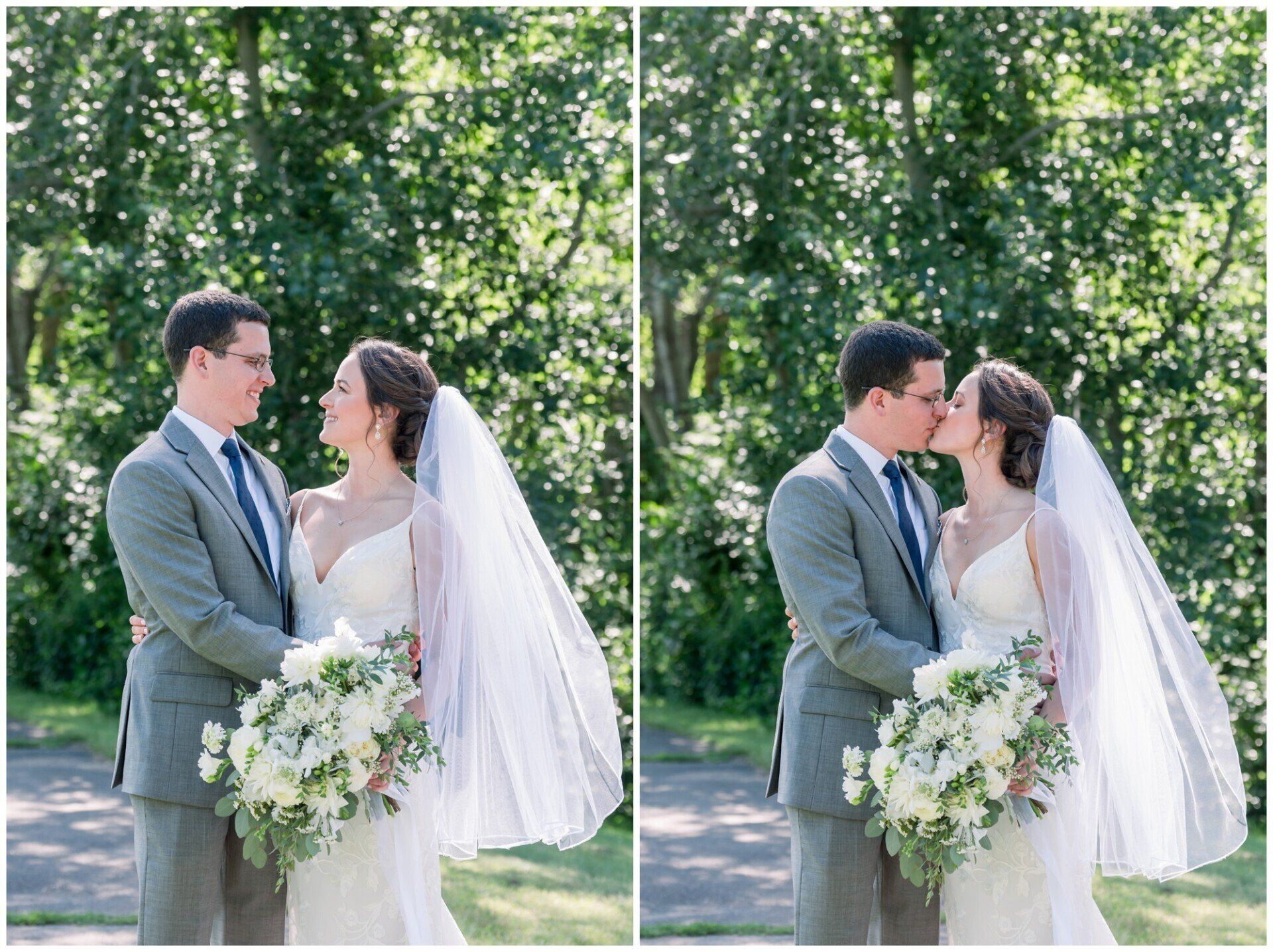 Bride and groom share a kiss outdoors in a sunlit garden, holding a white floral bouquet.