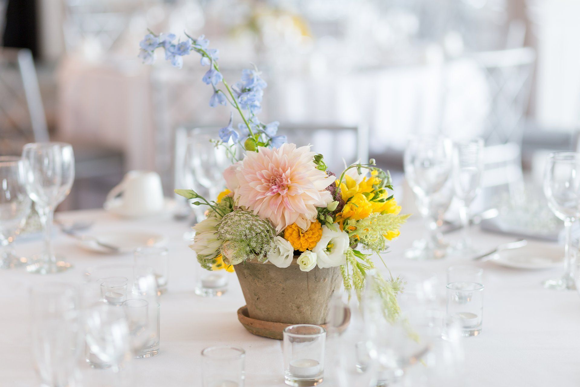 Pastel flower centerpiece on a white table at a formal event banquet