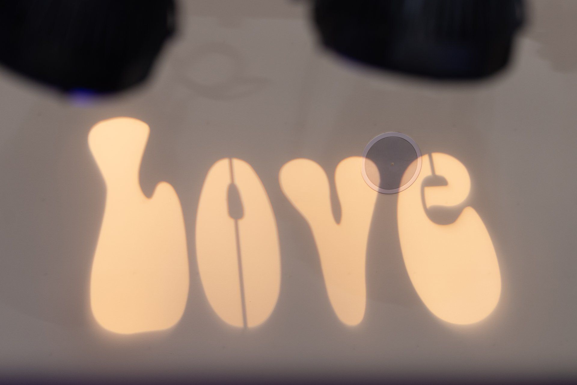 Glowing “love” sign in warm light on a dark background