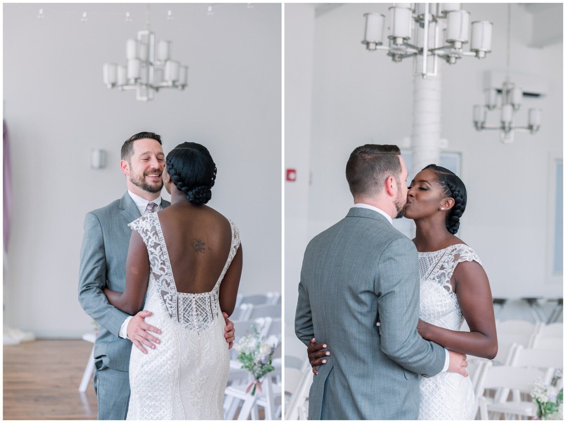 Couple in wedding attire sharing a kiss in a bright white room with chandeliers