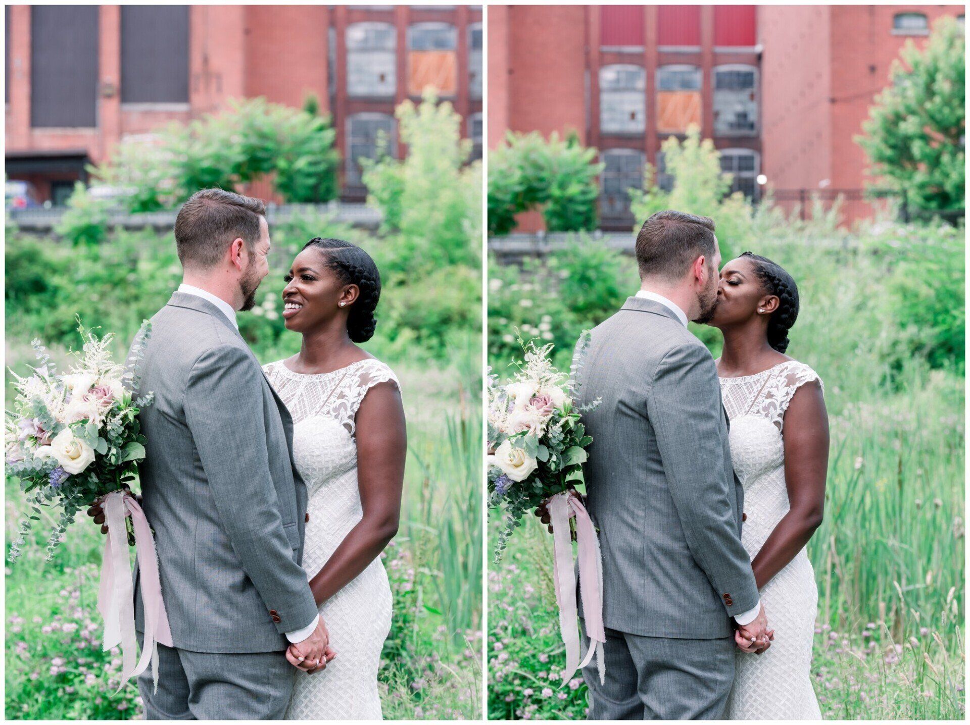 Couple embracing in a garden, with a brick building and flowers behind them.