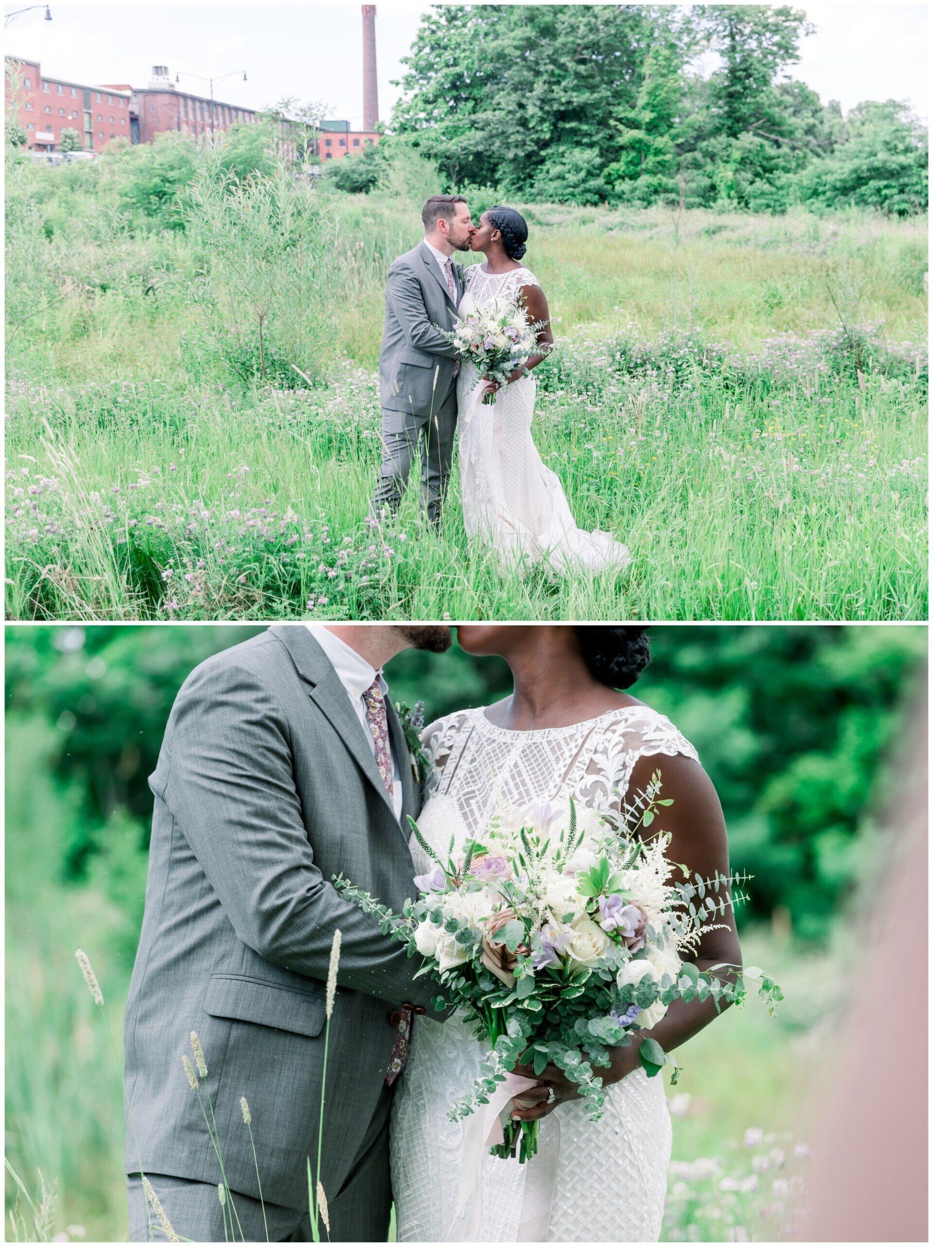 Bride and groom embracing in a green field, holding a white and pink bouquet