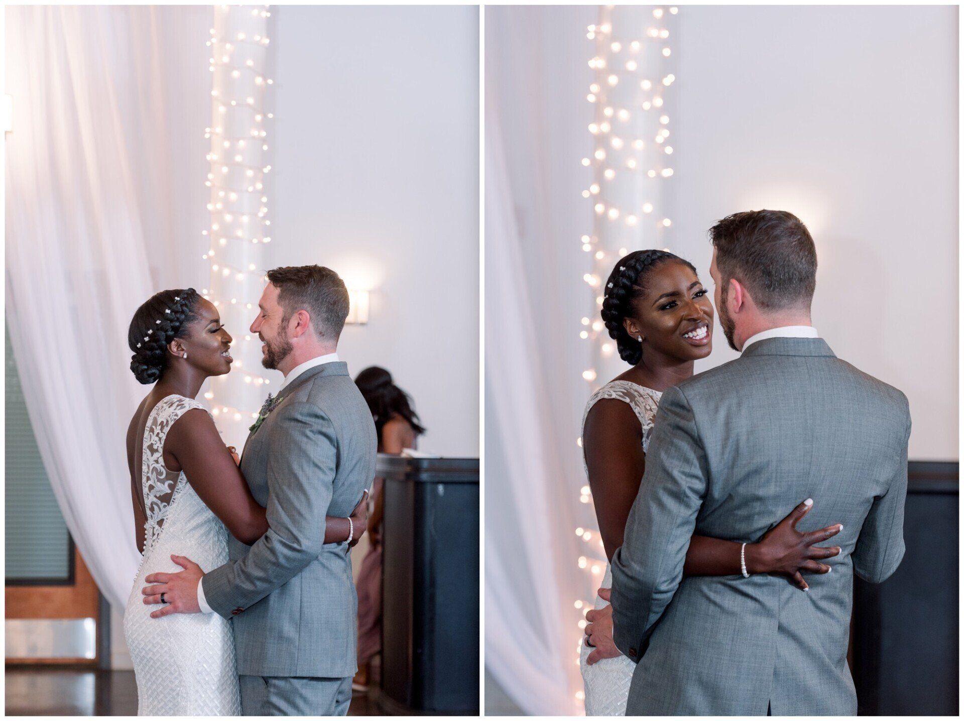 Couple in gray and white attire share a wedding dance indoors with twinkling lights behind them
