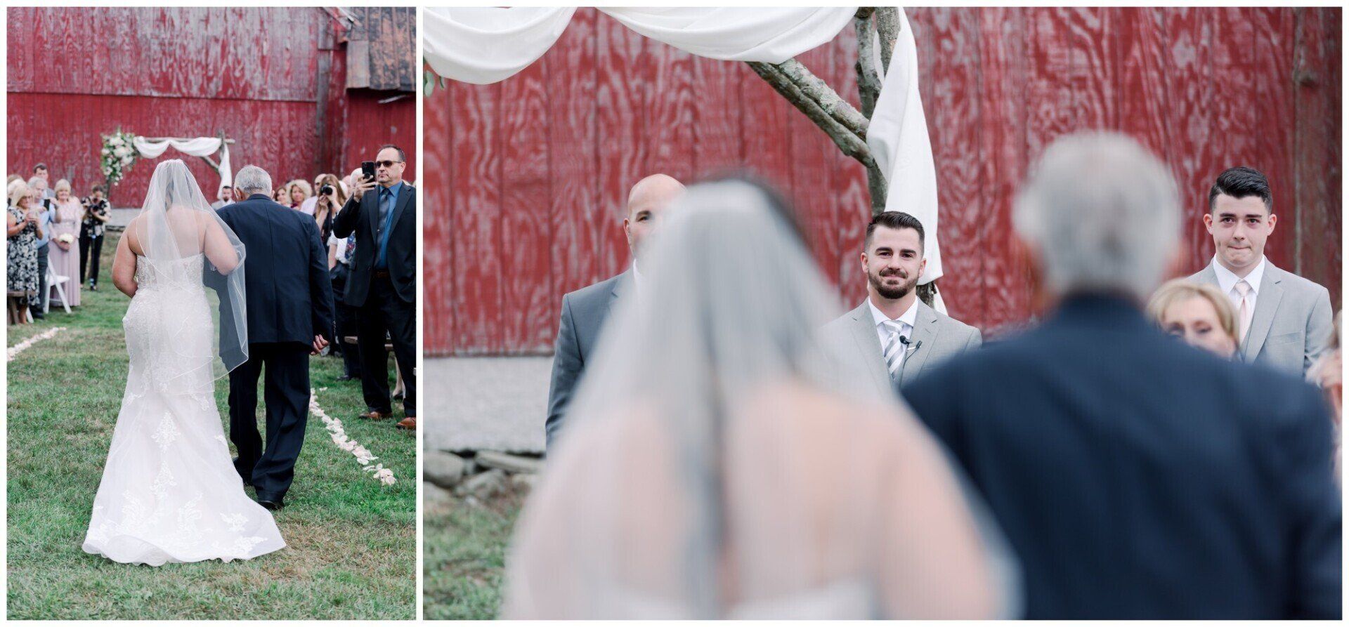 Wedding guests watch a bride in a white gown and veil at an outdoor ceremony with a red barn backdrop