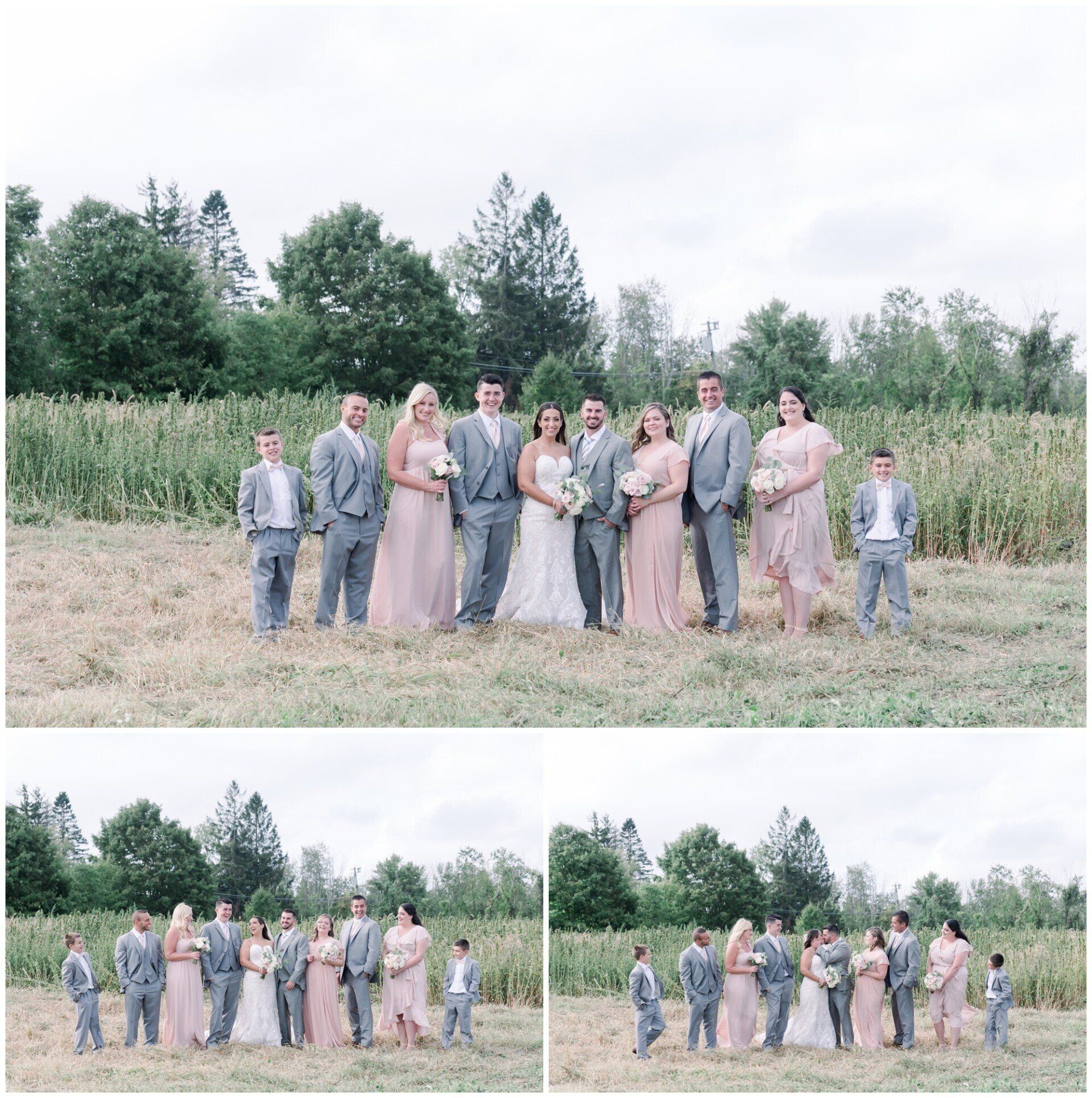 Group of people posing in formal attire in a grassy field with trees in the background.