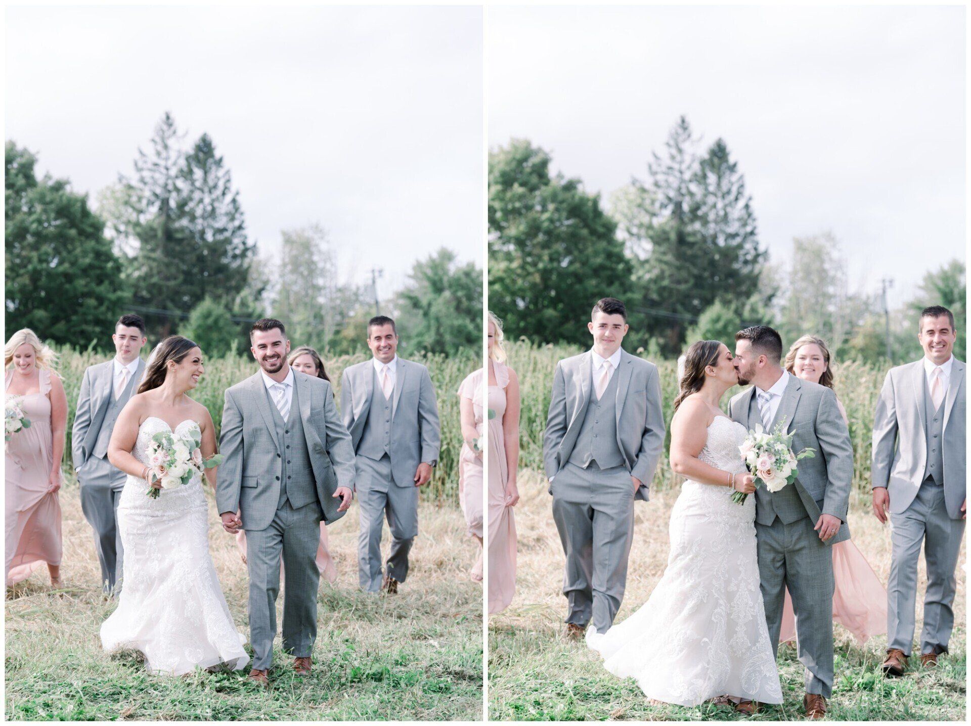 Wedding party walking outdoors in a grassy field, with bride and groom smiling among guests.