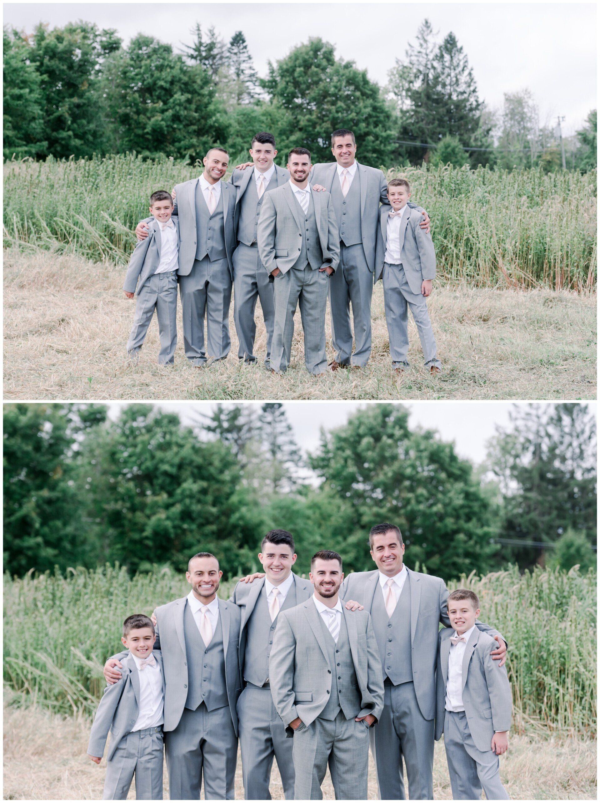 Two men and two boys in gray suits standing outdoors in a grassy field, with trees behind them.