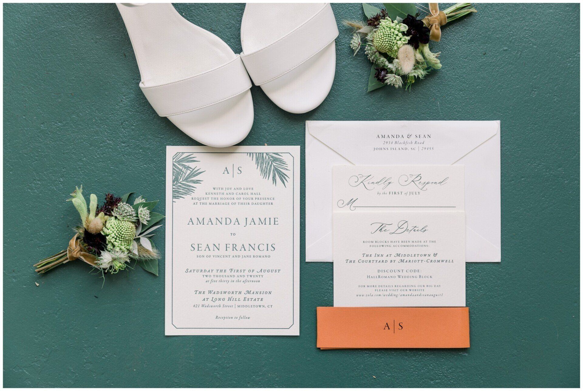 Wedding invitation suite with white shoes and floral accents on a green background