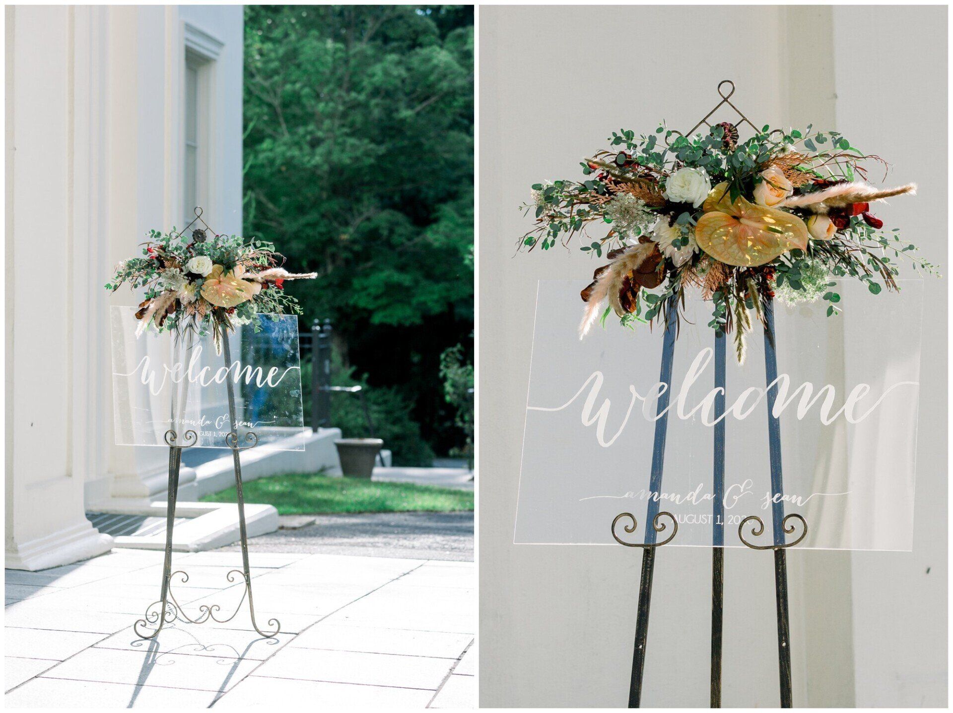 Floral welcome sign on a metal stand by a windowed doorway, with white script text and greenery outside.