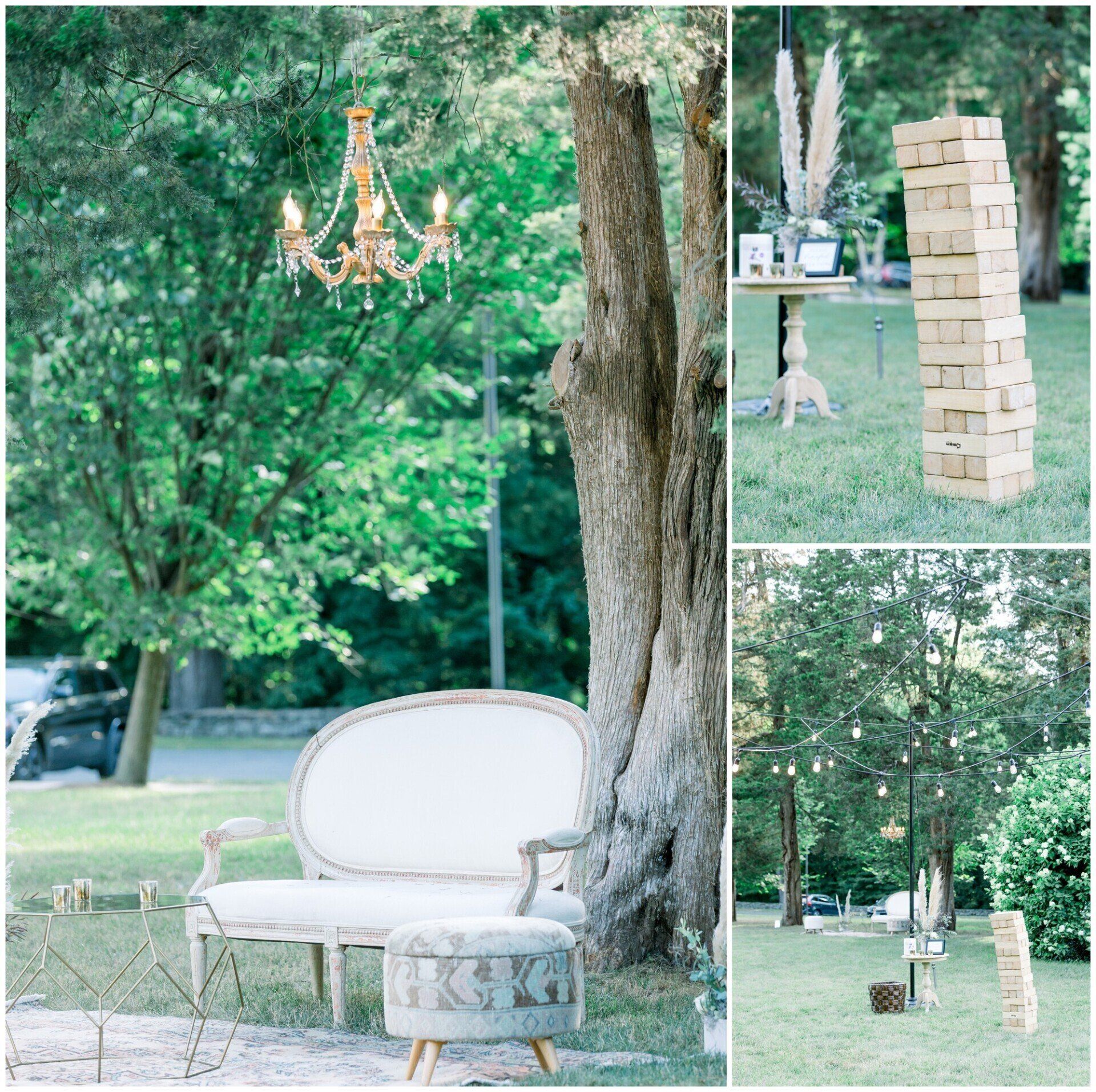 Outdoor art installation with white sofa, chandelier, giant Jenga, and trees in a park-like setting
