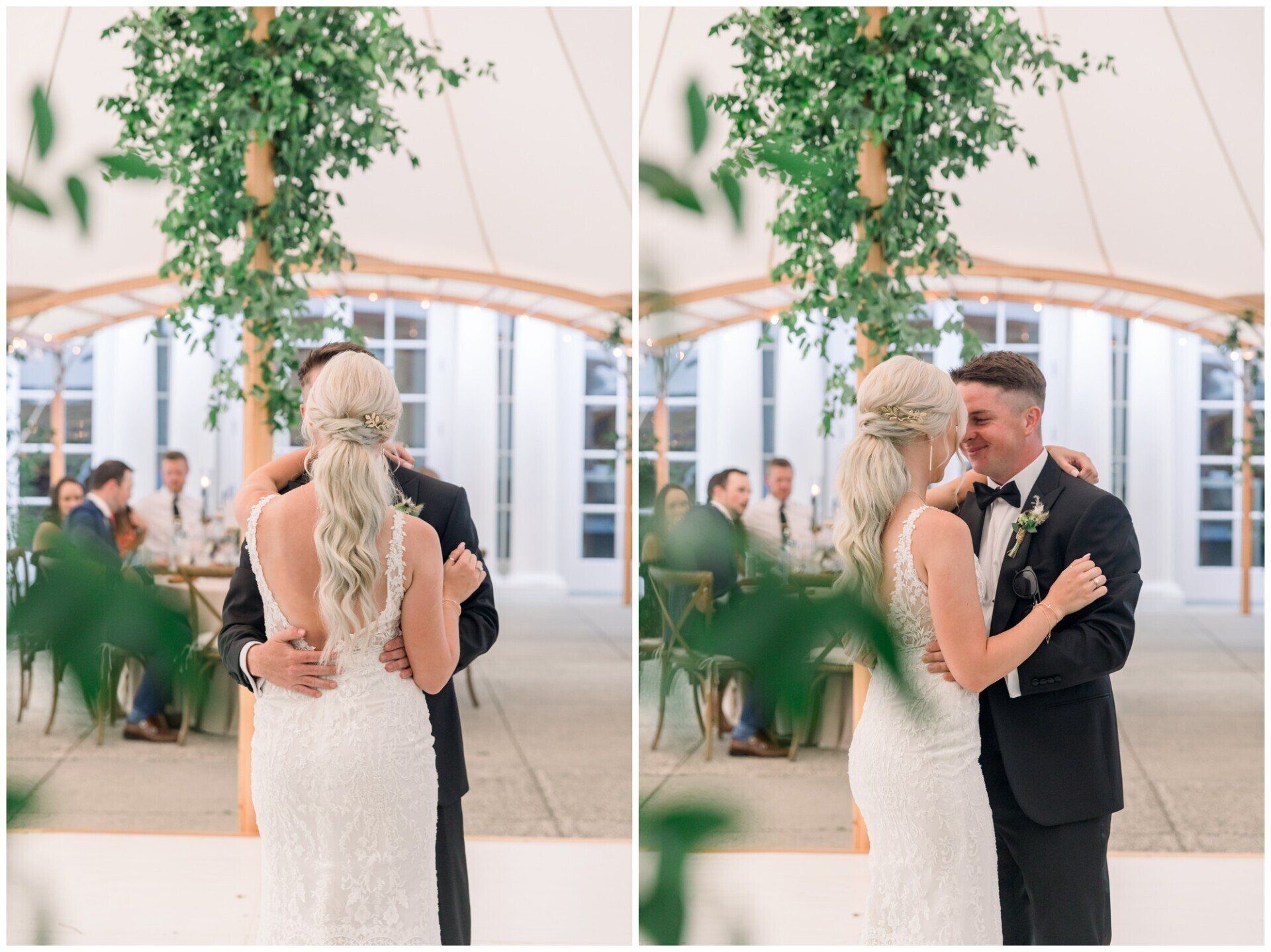 Bride and groom slow dance under greenery at an outdoor wedding reception