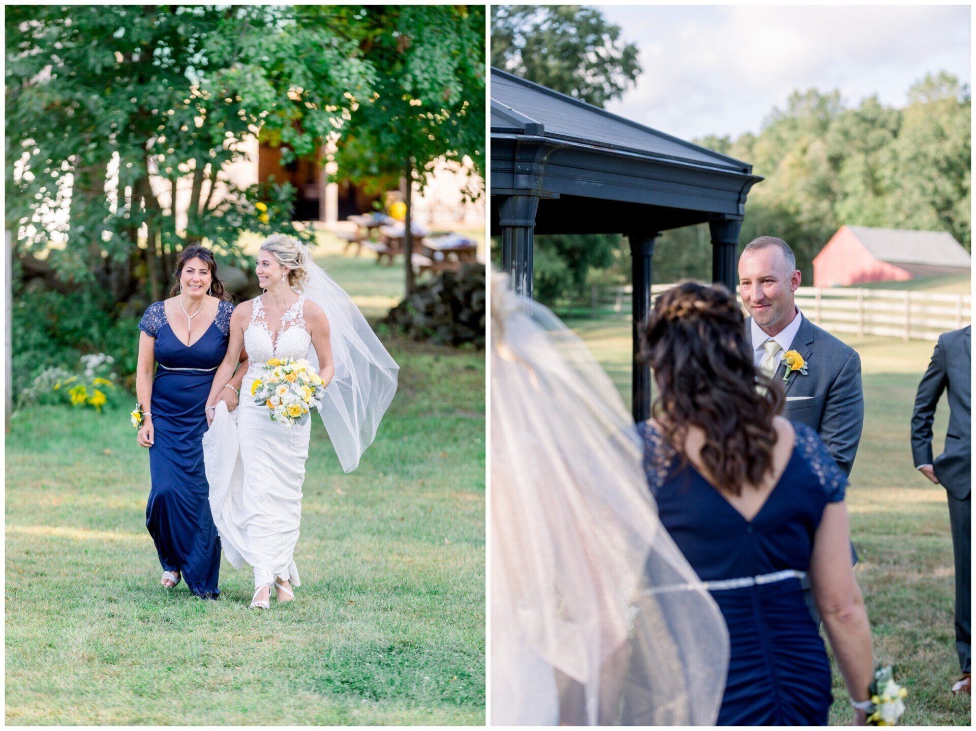 Bride in white walks with woman in navy dress at an outdoor wedding ceremony