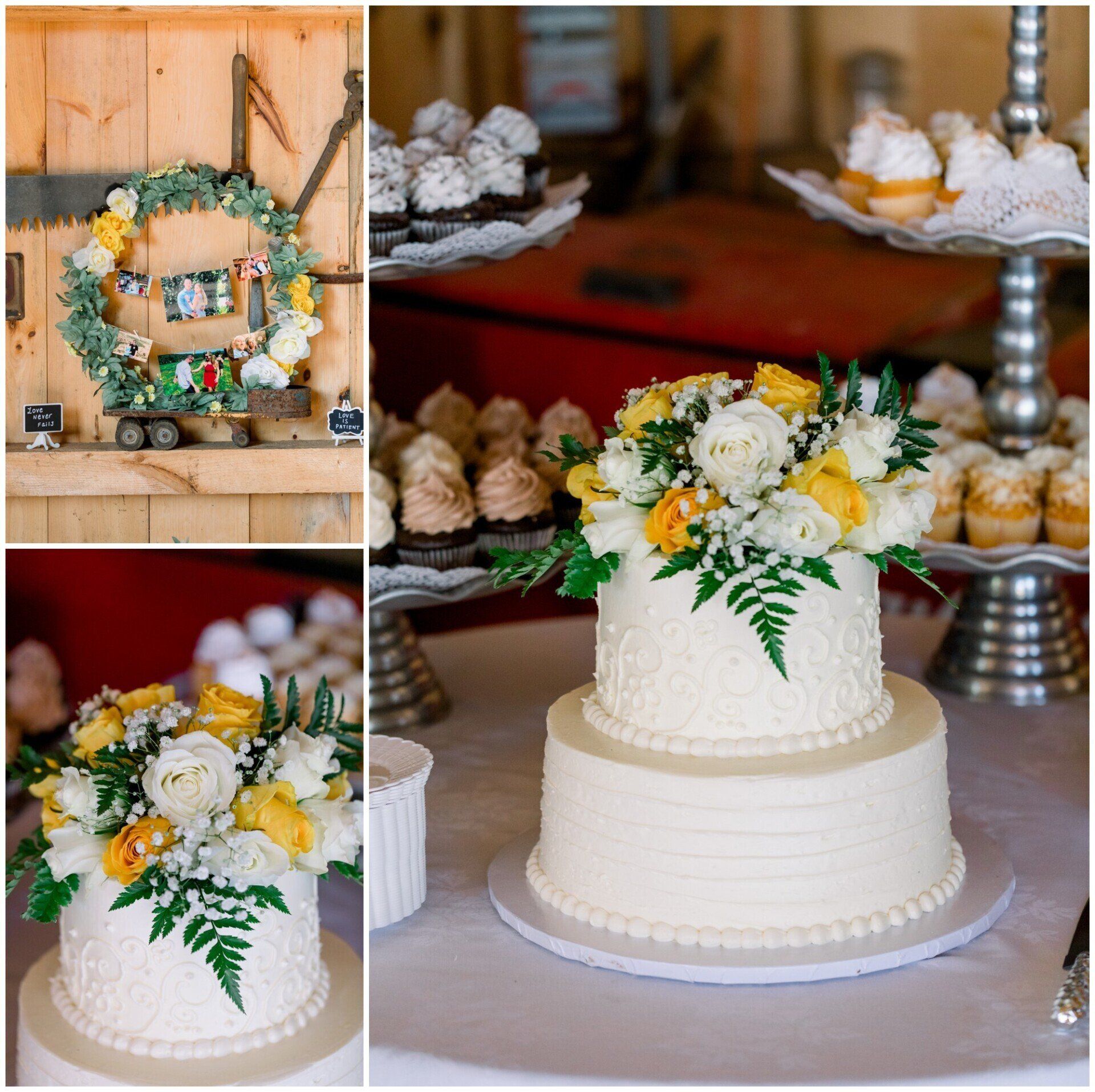 Rustic wedding cake with white frosting and yellow-white flowers on a dessert table, with floral wreath decor nearby