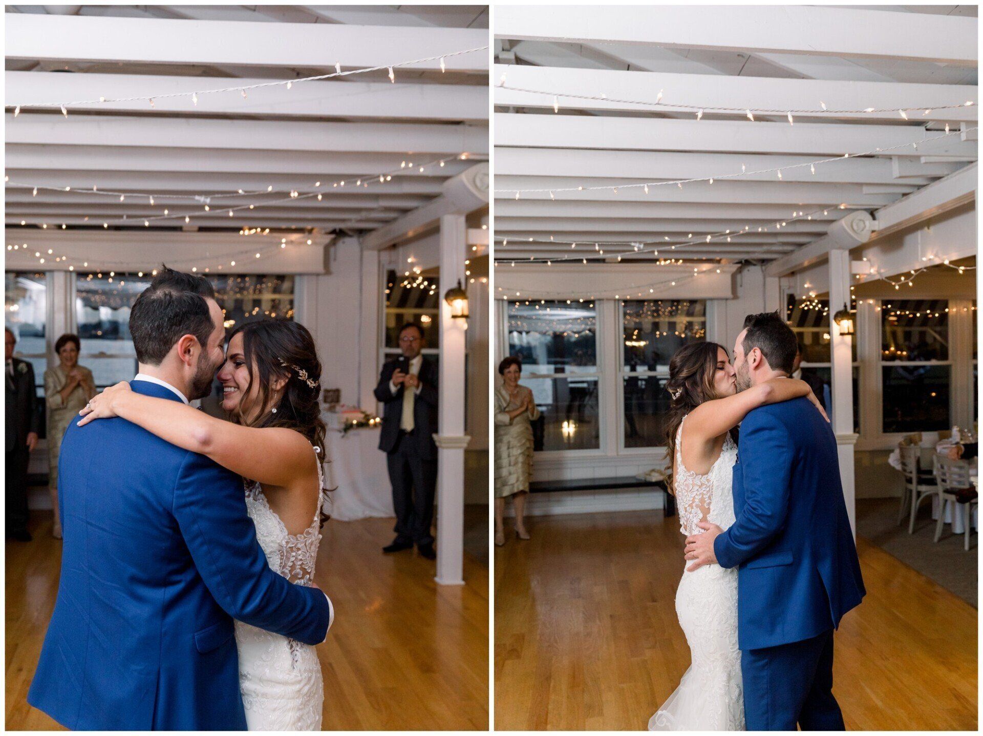 Couple embracing and kissing at a wedding reception in a bright indoor venue