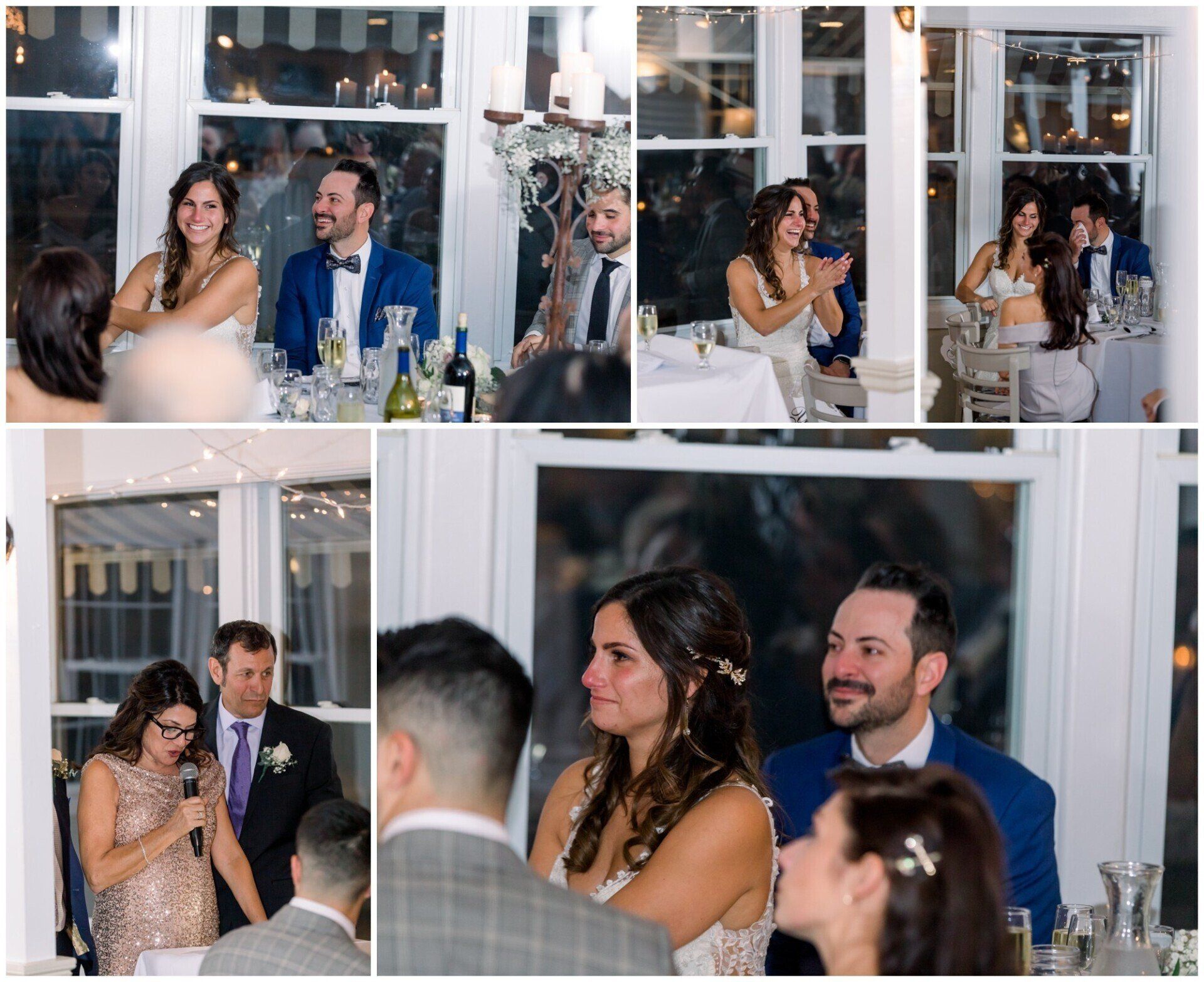 Wedding guests applauding at a reception, with a smiling couple seated at a table near a windowed venue.