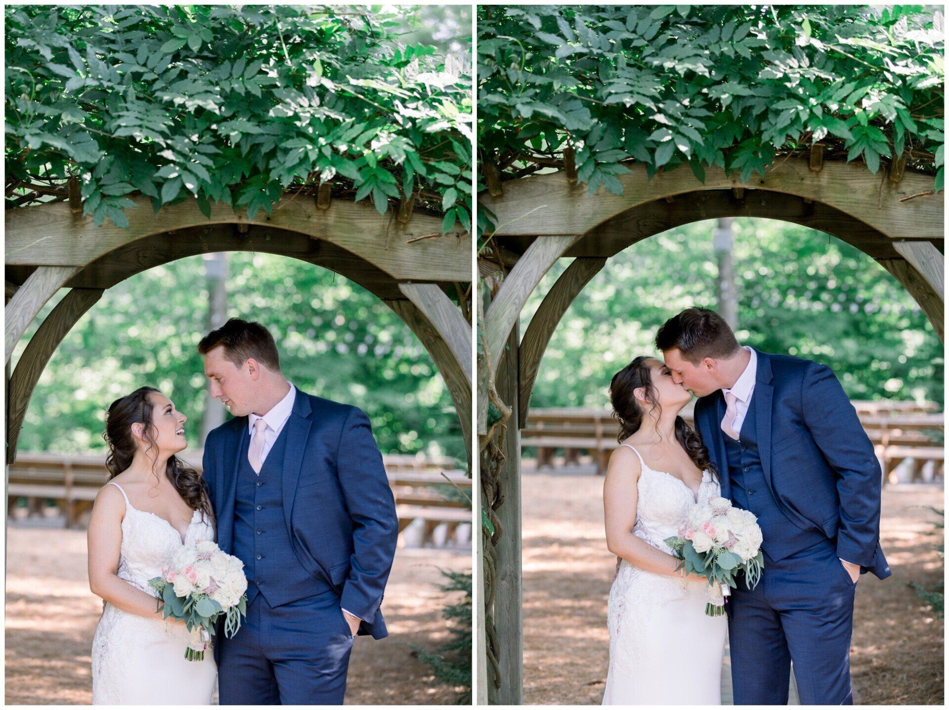 Bride and groom kiss beneath a leafy garden arch, holding a white bouquet.