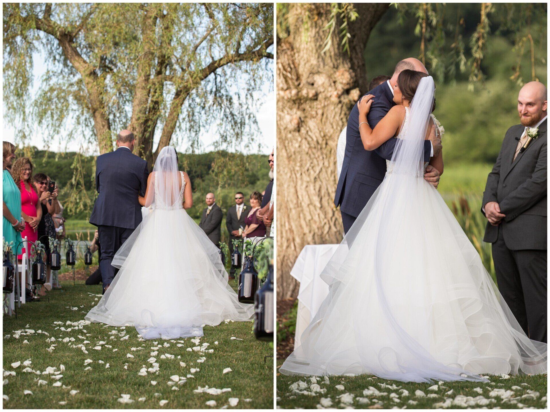 Bride and groom kiss beneath a tree during an outdoor wedding ceremony