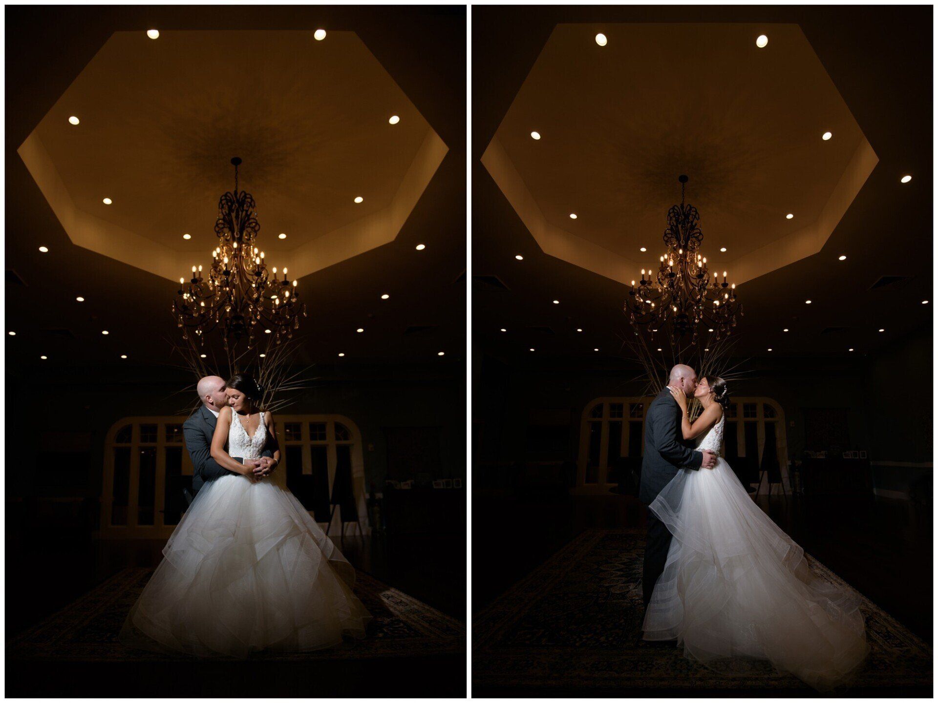 Bride and groom embrace in a dimly lit ballroom beneath a chandelier, with wedding cake visible.