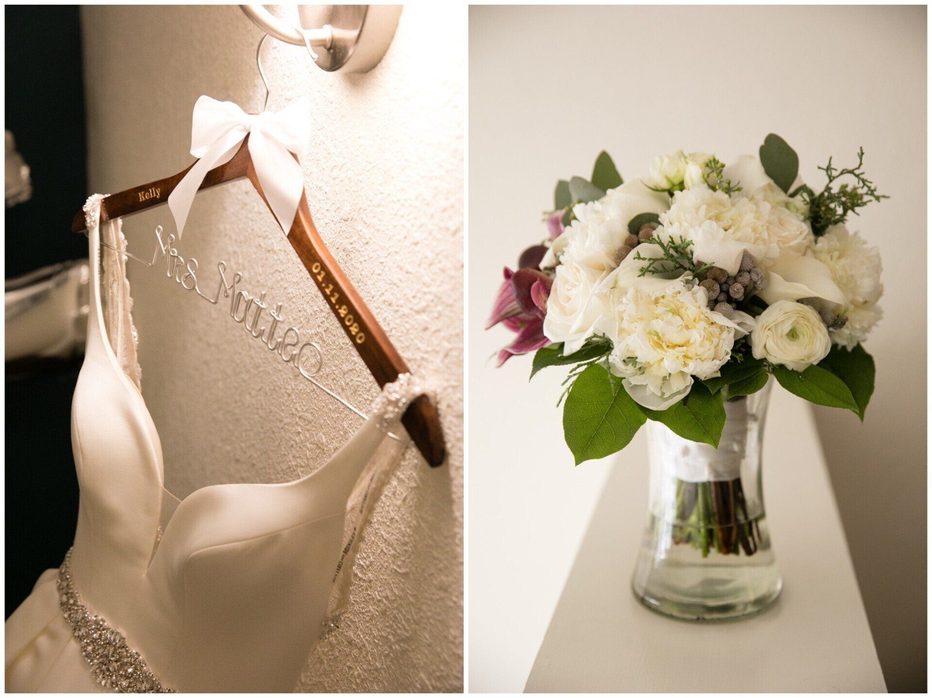 White bridal gown on hanger beside a vase of white and green flowers
