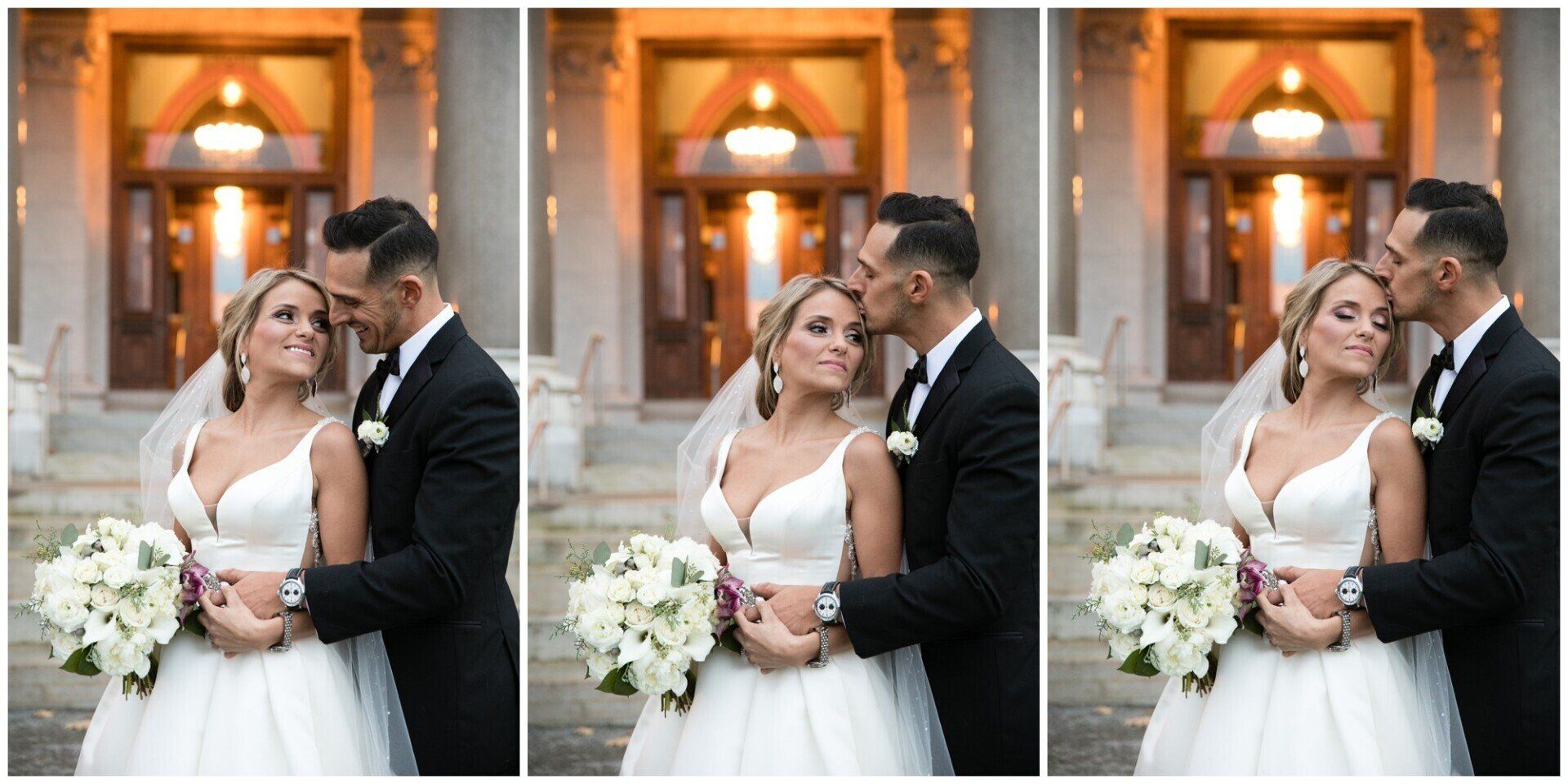 Bride and groom embracing in front of warm-lit church doors, holding a white bouquet