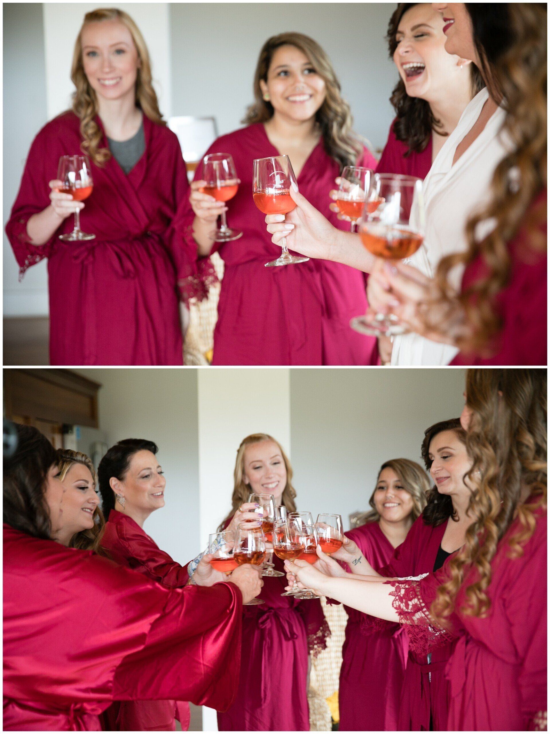 Women in matching pink robes toast drinks together at a festive indoor gathering.