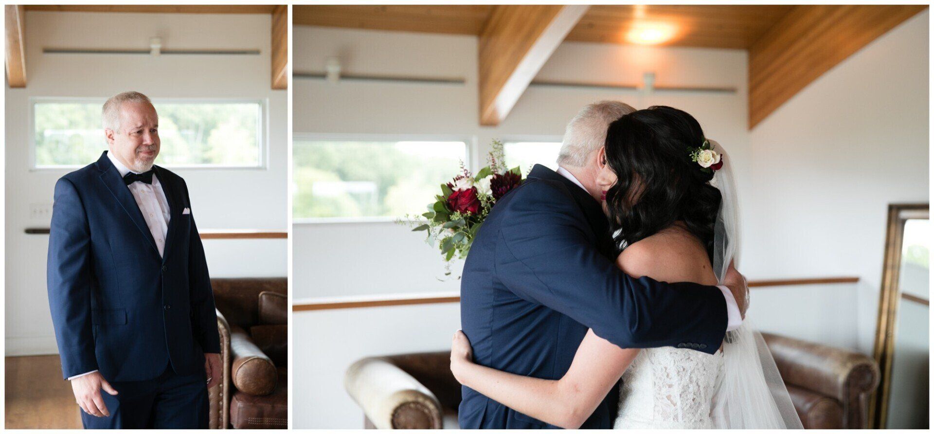 Man in dark suit embraces bride in white dress in a bright wooden room; another man stands nearby.
