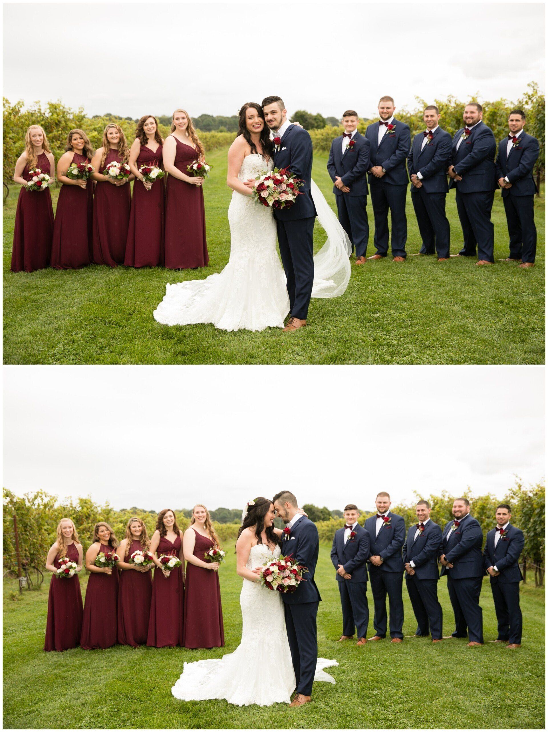 Wedding couple kissing on a lawn, with bridal party lined up behind them in maroon and navy attire.