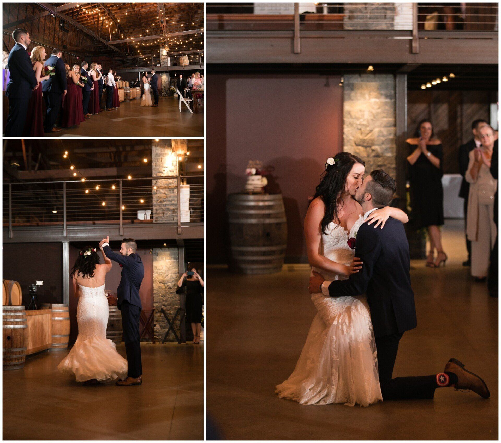 Wedding couple dancing and kneeling in a warmly lit reception hall, with guests applauding in the background