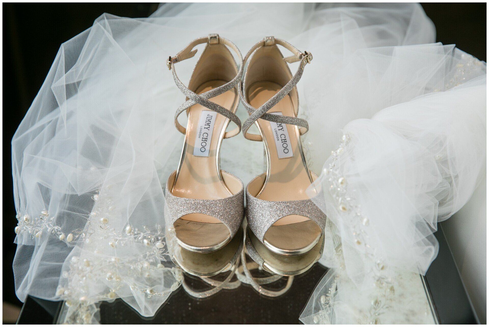 Gold bridal heels on white tulle fabric