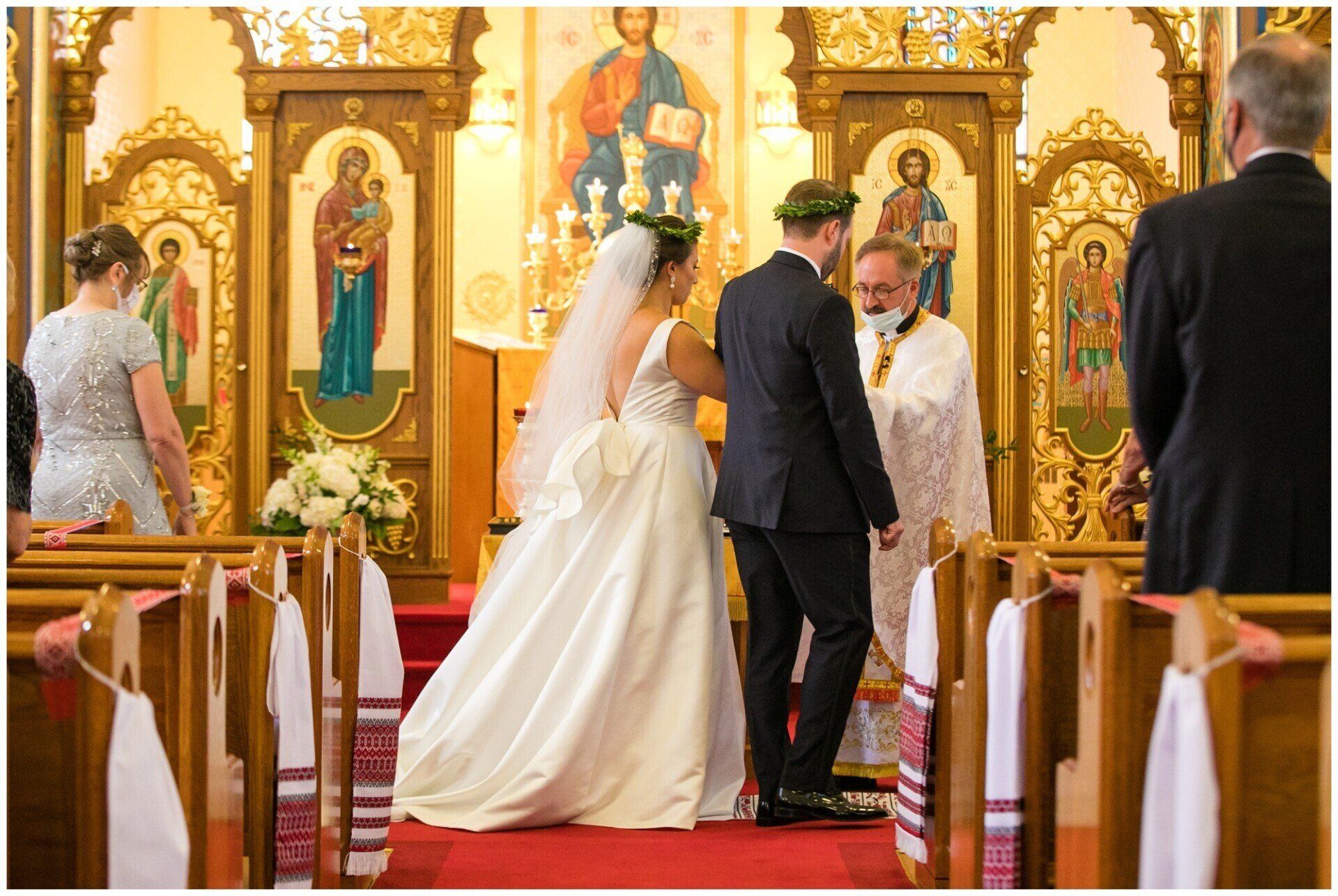 Bride and groom stand at the altar in a church during a wedding ceremony.
