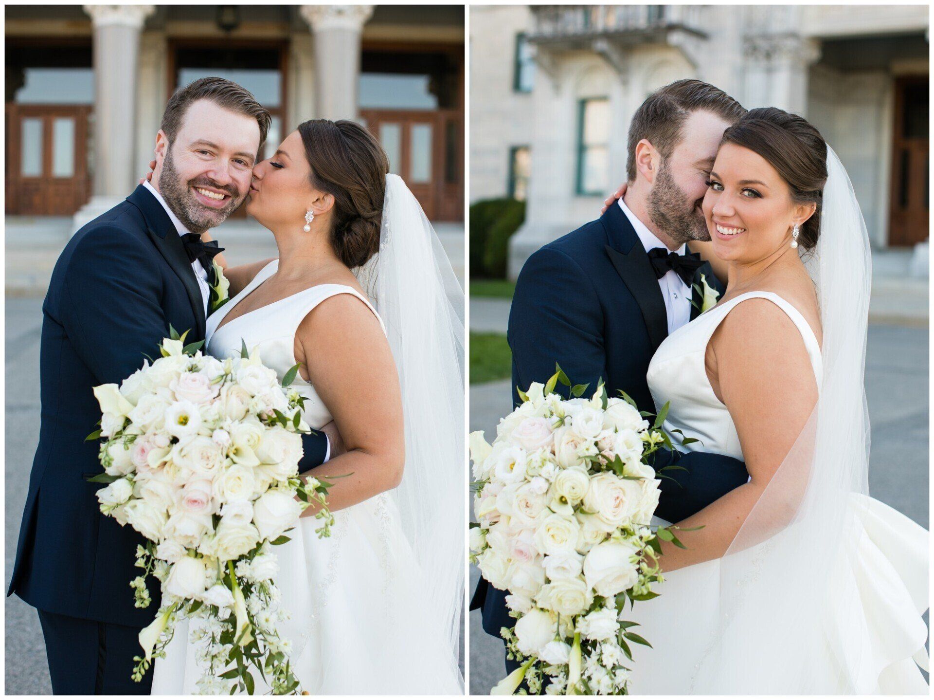 Bride and groom posing with a white bouquet outside a building, smiling on their wedding day