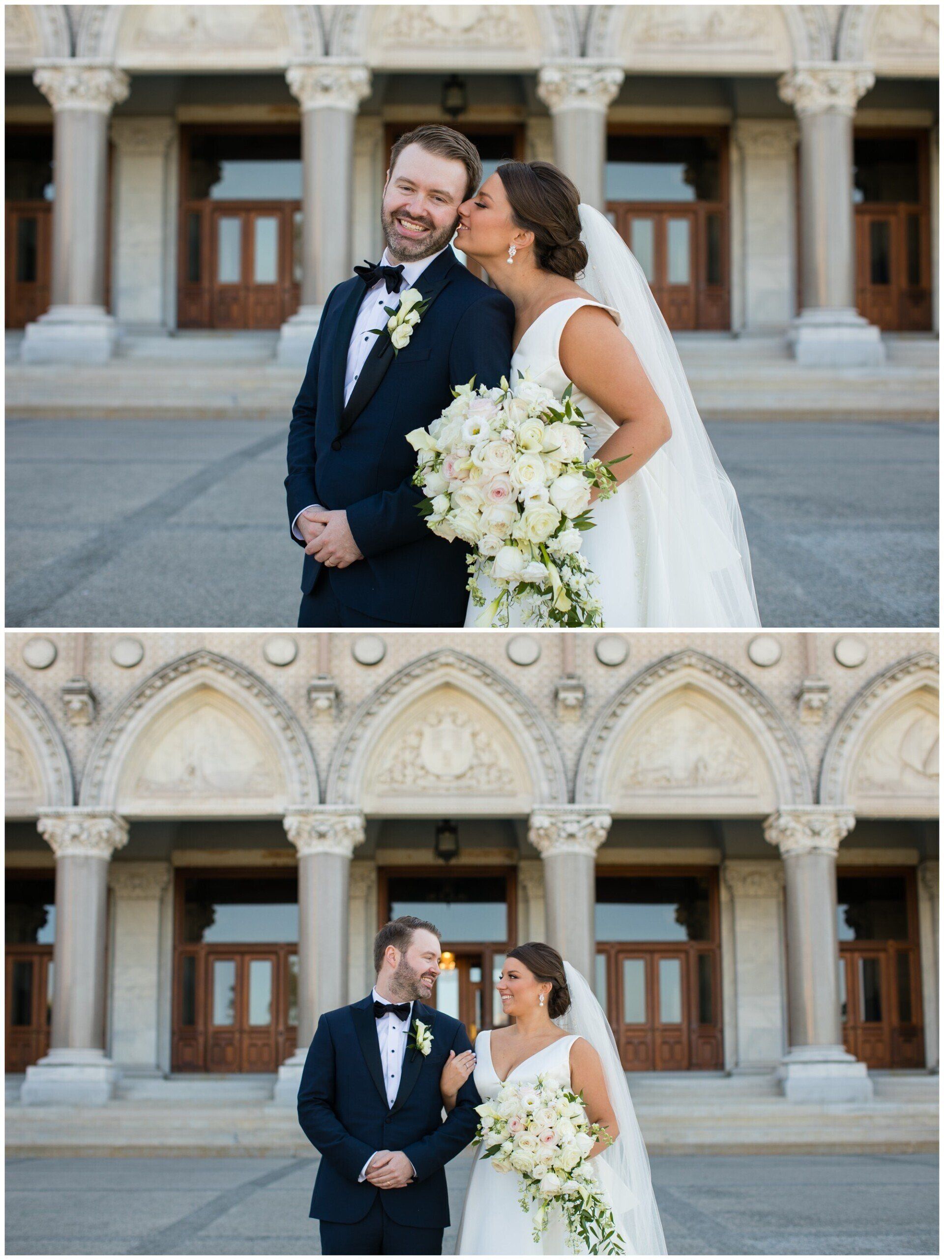 Bride and groom posing and laughing in front of an ornate stone building
