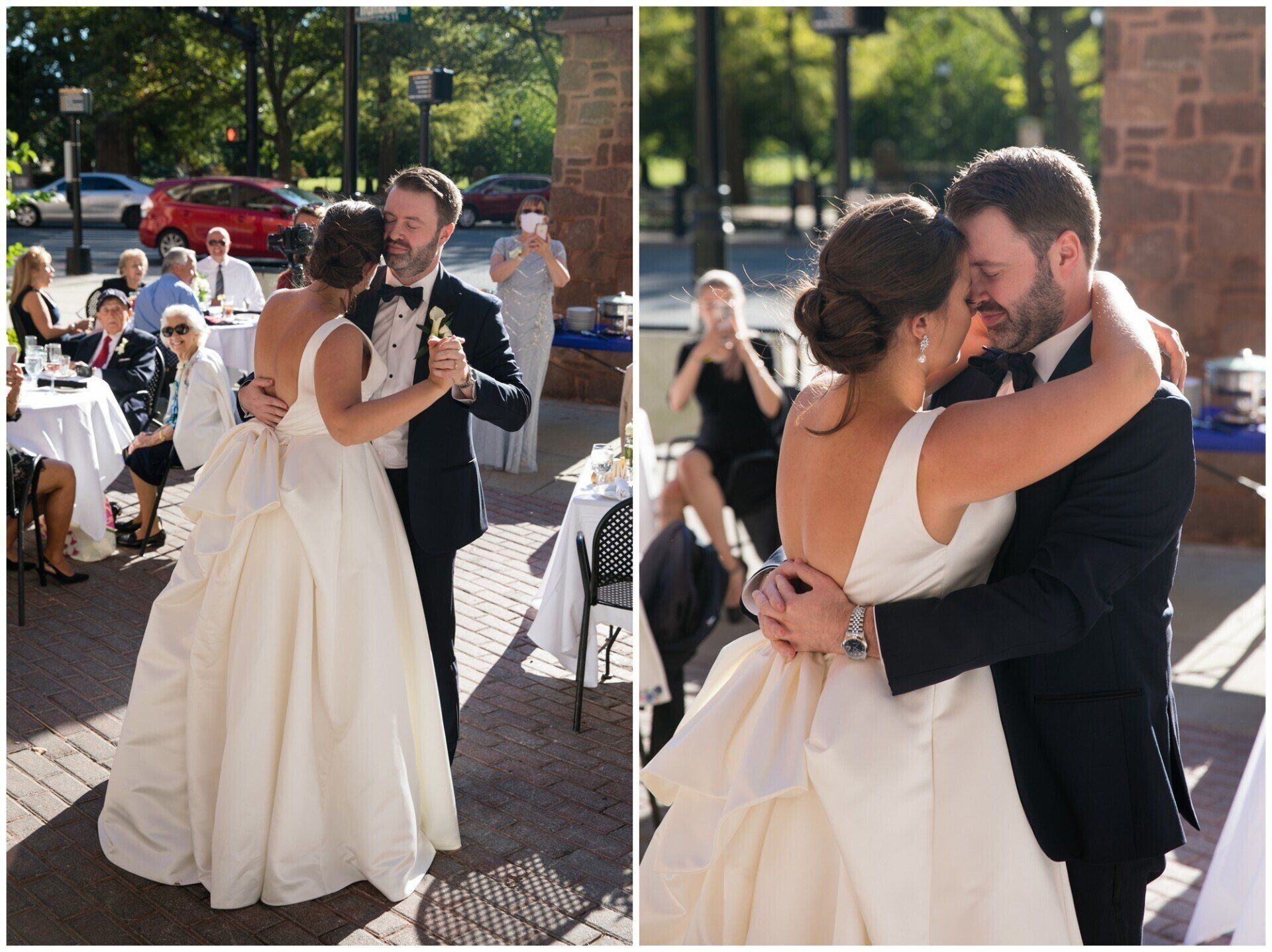 Bride and groom slow dance at an outdoor wedding reception, embracing in formal attire.